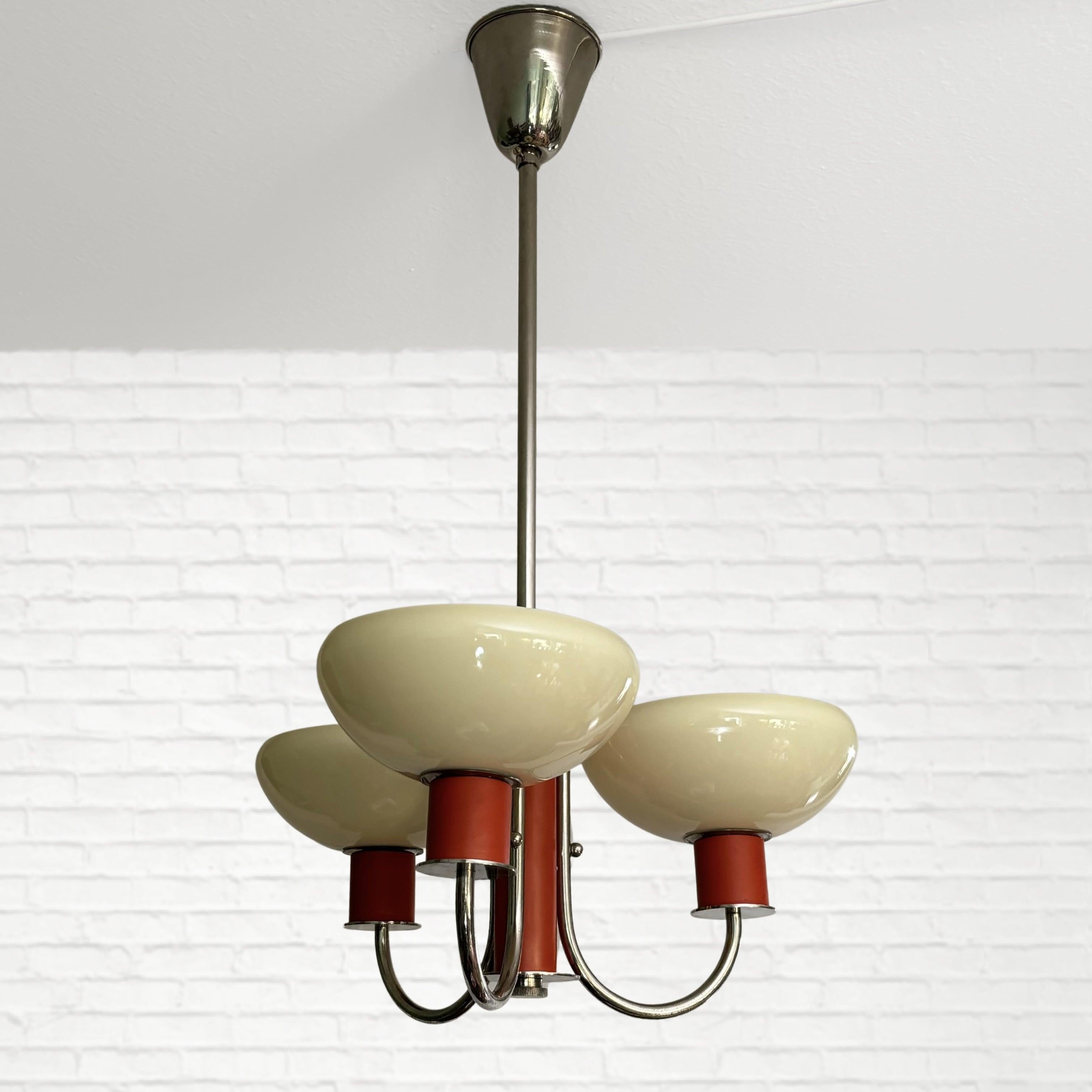 A beautiful Swedish modernist chandelier attributed to Erik Tidstrand for the renowned Swedish department store Nordiska Kompaniet. Produced in the 1930s, during a time when functionalism had its breakthrough in Scandinavia. Crafted from steel and