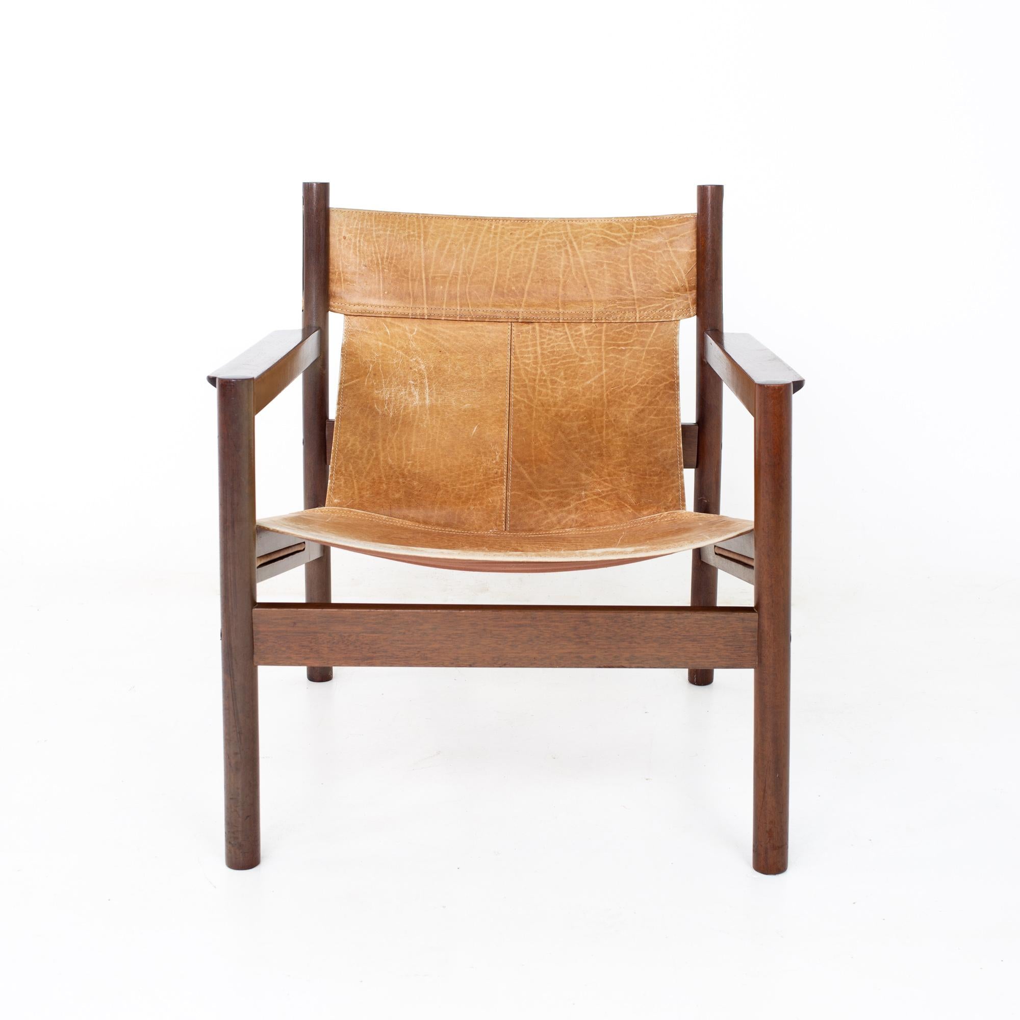 Erik Worts Arne Norell Safari style mid century leather sling lounge chair

Chair measures: 25.75 wide x 26.5 deep x 29 high, with a seat height of 15 inches and arm height of 21.5 inches

All pieces of furniture can be had in what we call restored