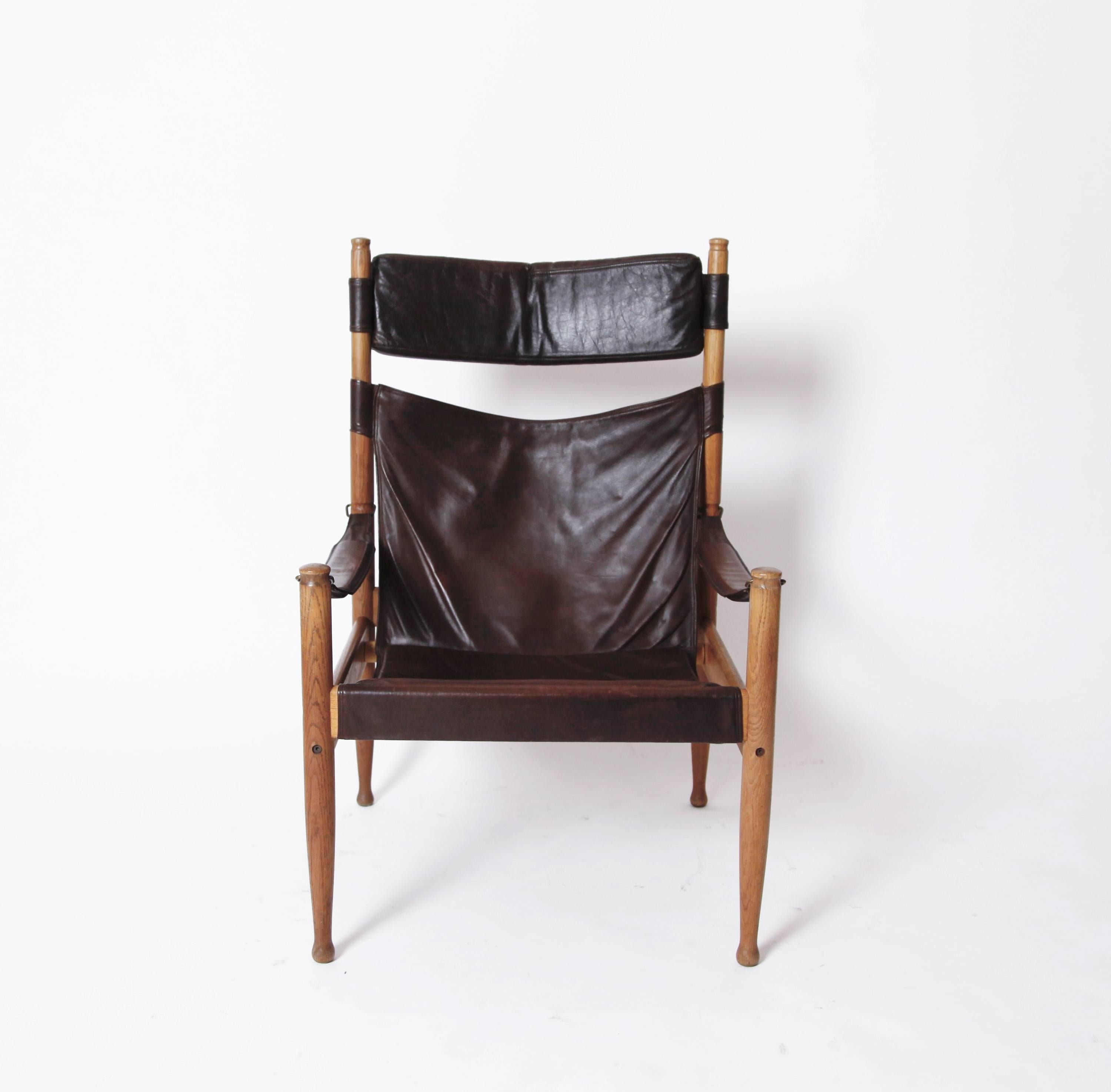 Erik Worts' high back iteration of the classic safari chair is quite beautiful. The oak legs are slender and curvaceous, there is a cushioned headrest and loose seat cushion, and the dark burgundy leather overall is soft and wonderfully aged.