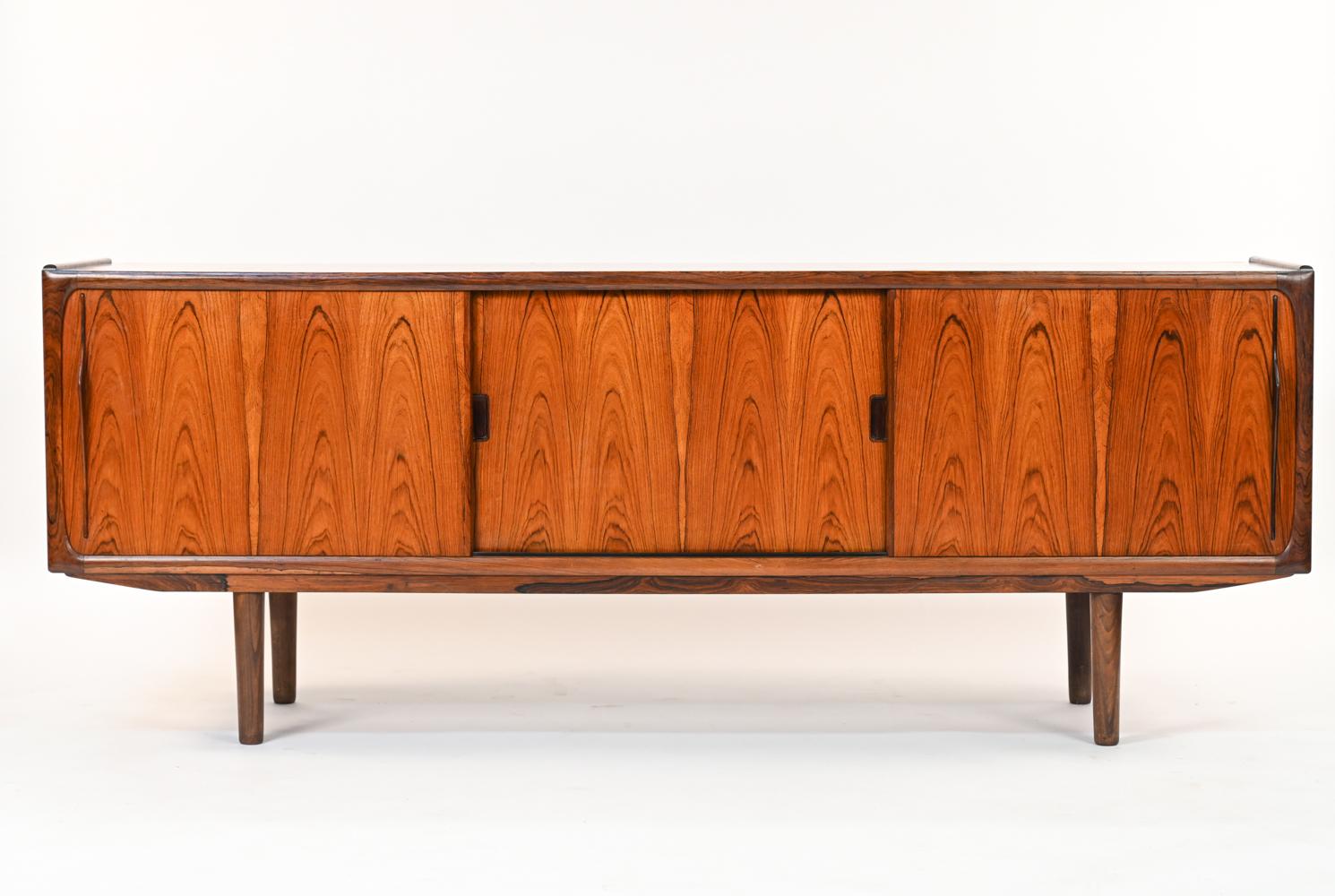 A handsome Danish mid-century sideboard in rosewood book-matched veneer designed by Erik Wørts for Møbelfarikken Norden. Featuring mahogany shelves to interior with stunning grain. With manufacturer's label to back.