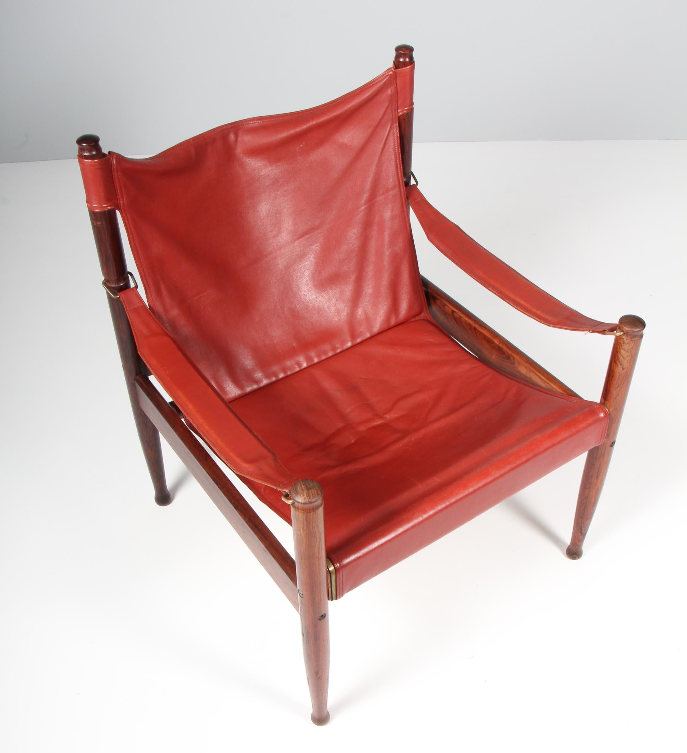 Erik Wørts safarichair made in solid rosewood. 

Original red patinated leather upholstery.

Made by N. Eilersen.
 