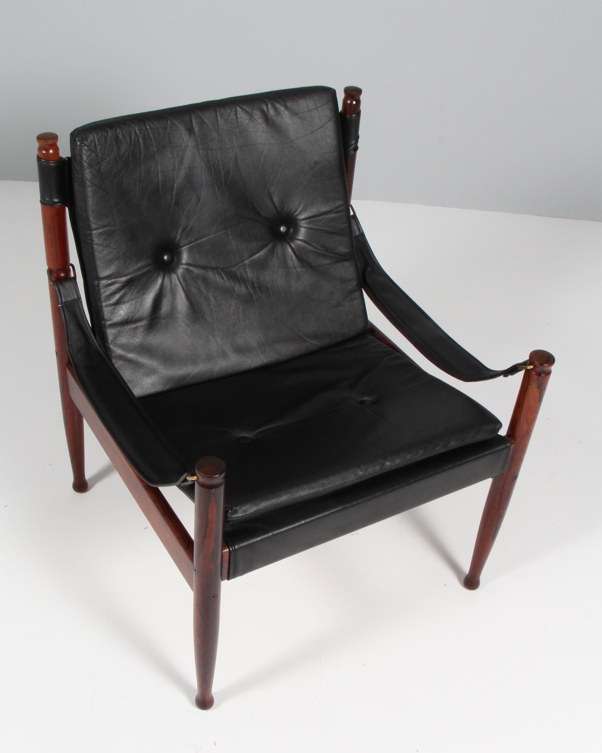 Erik Wørts safarichair made in solid rosewood. 

Original black patinated leather upholstery.

Made by N. Eilersen.
 