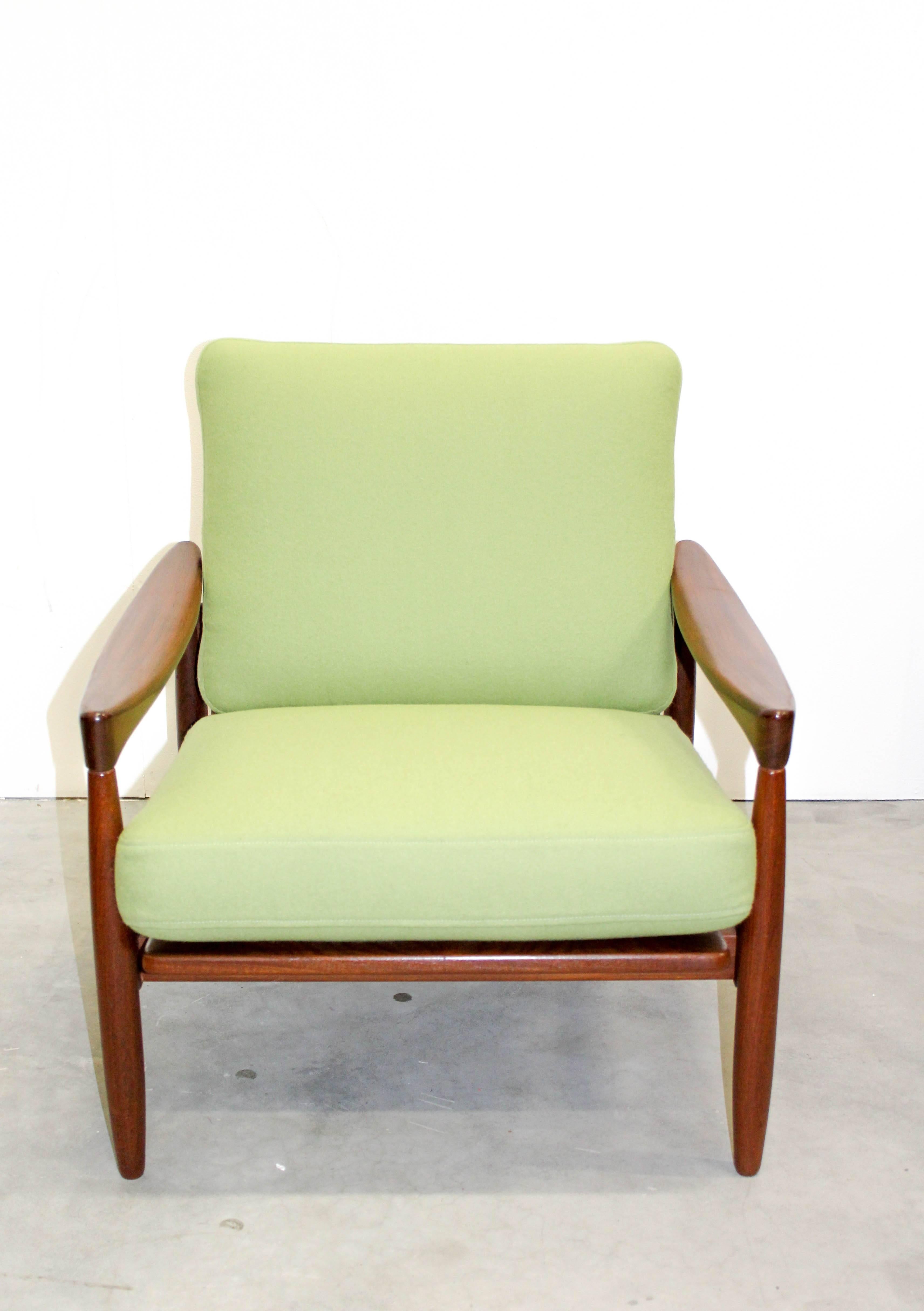 A solid teak lounge chair by Danish designer Erik Wørts. This chair has been professionally upholstered in a lime green wool fabric (100% wool from Klippan Yllefabrik). The chair is in excellent vintage condition and reupholstered. 

