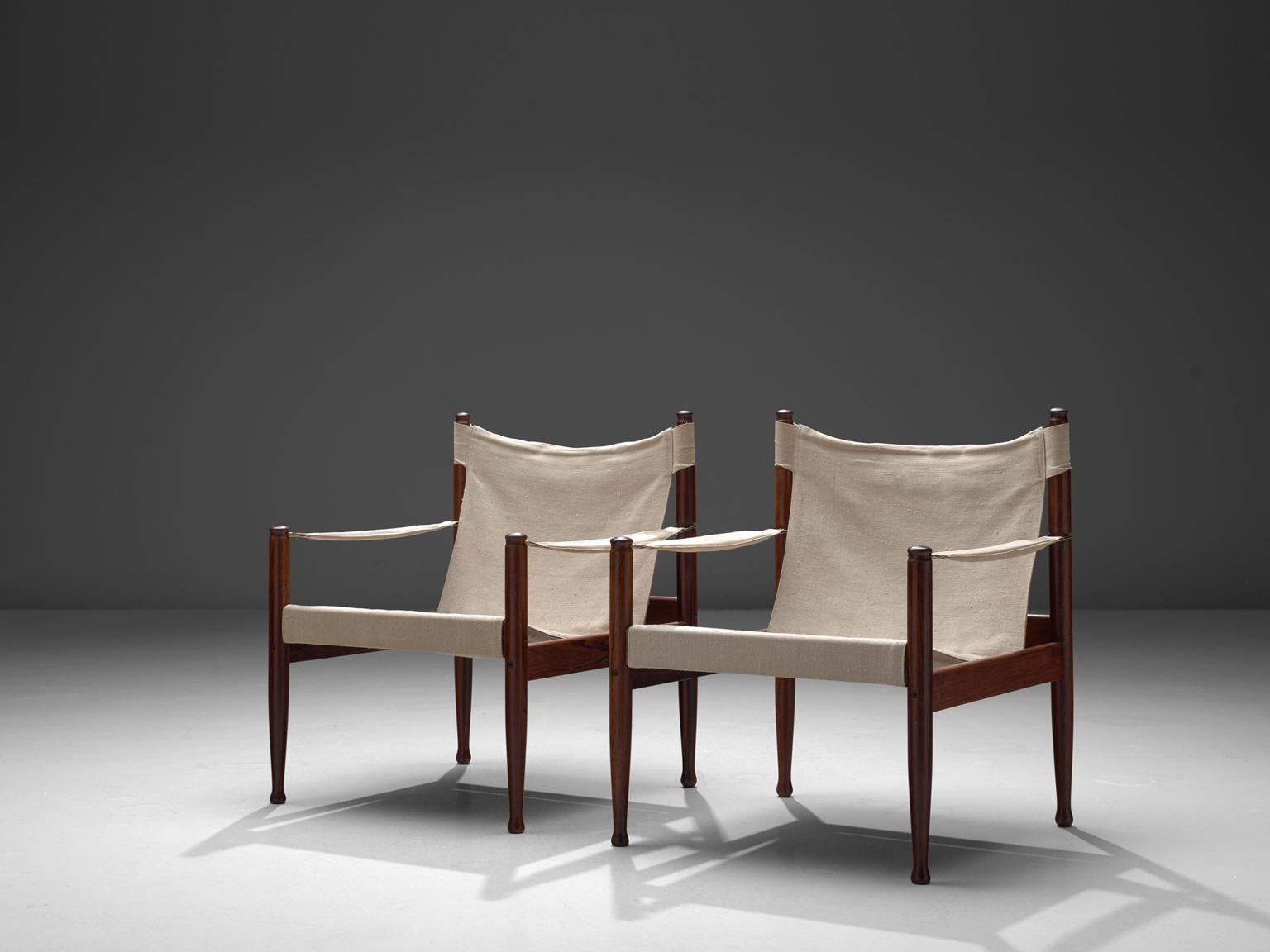 Erik Wørts for Niels Eilsersen, set of two armchairs, rosewood, brass and canvas, Denmark, 1960s. 

These sturdy lounge chairs with refined detail are designed by Danish designer Erik Wørts. The safari easy chairs have a laidback expression due to