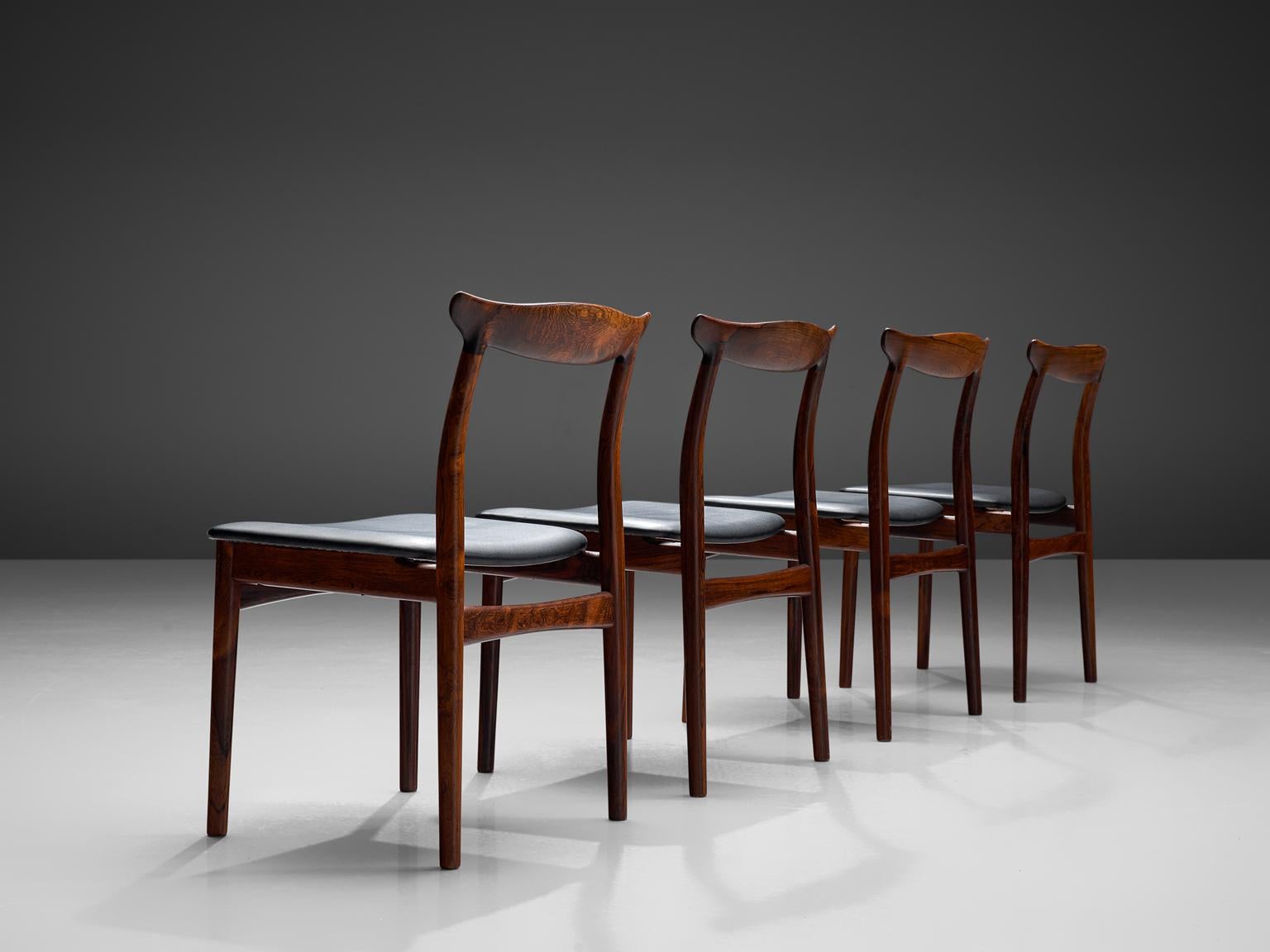 Erik Wørts for Vamo Møbelfabrik, set of four dining chairs model 112, rosewood and leather, Denmark, 1950s. 

Set of four dining room chairs in rosewood and recently reupholstered in black leather. The four cylindrical legs are tapered and run