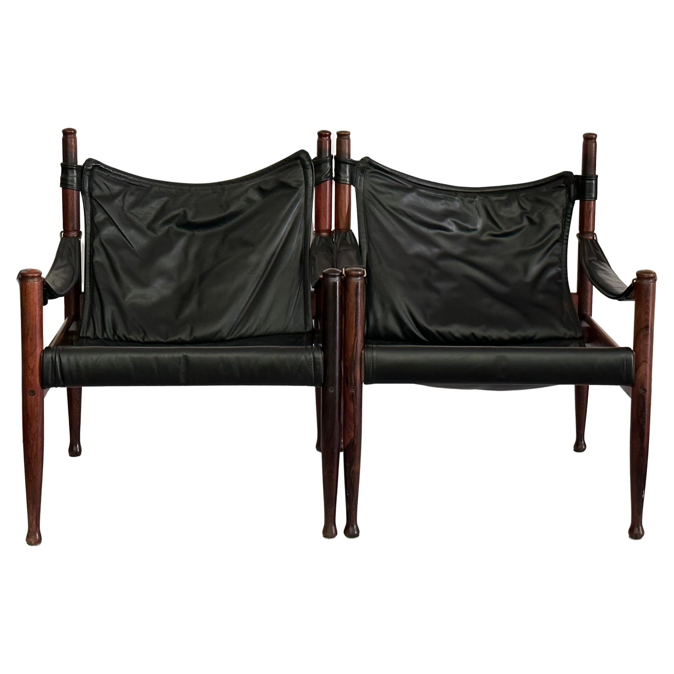 A fantastic highback pair of safari lounge chairs in beautiful rosewood  and black leather designed by Erik Wørts for Niels Eilersen, Denmark, manufactured in midcentury, circa 1960 (late 1950s or early 1960s). A very dynamic design with soft