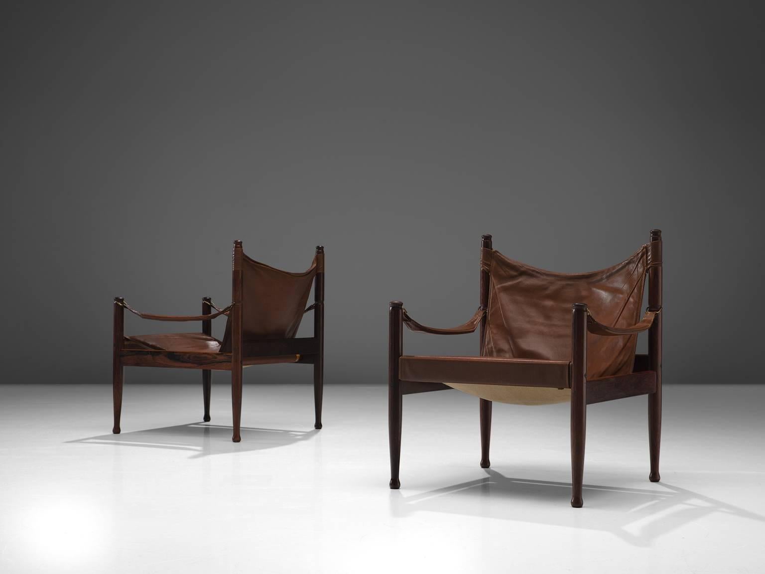 Erik Wørts for Niels Eilsersen, set of two armchairs, rosewood and leather, Denmark, 1960s. 

Sturdy lounge chairs with refined details. These safari easy chairs get a strong expression by the leather armrests and seating and back. The wooden frame