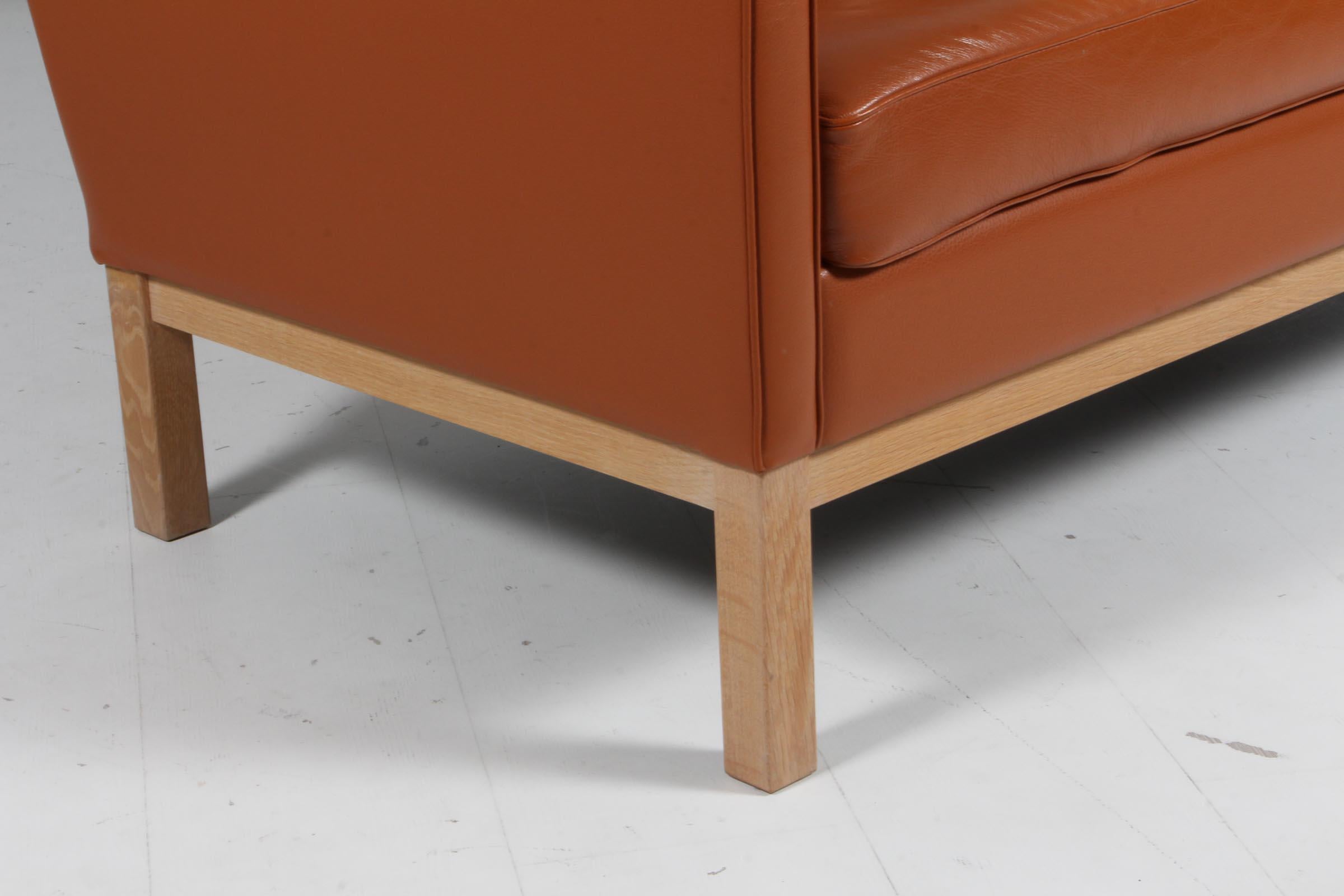 Mid-20th Century Erik Wørts two seat sofa, cognac leather, oak, Denmark For Sale