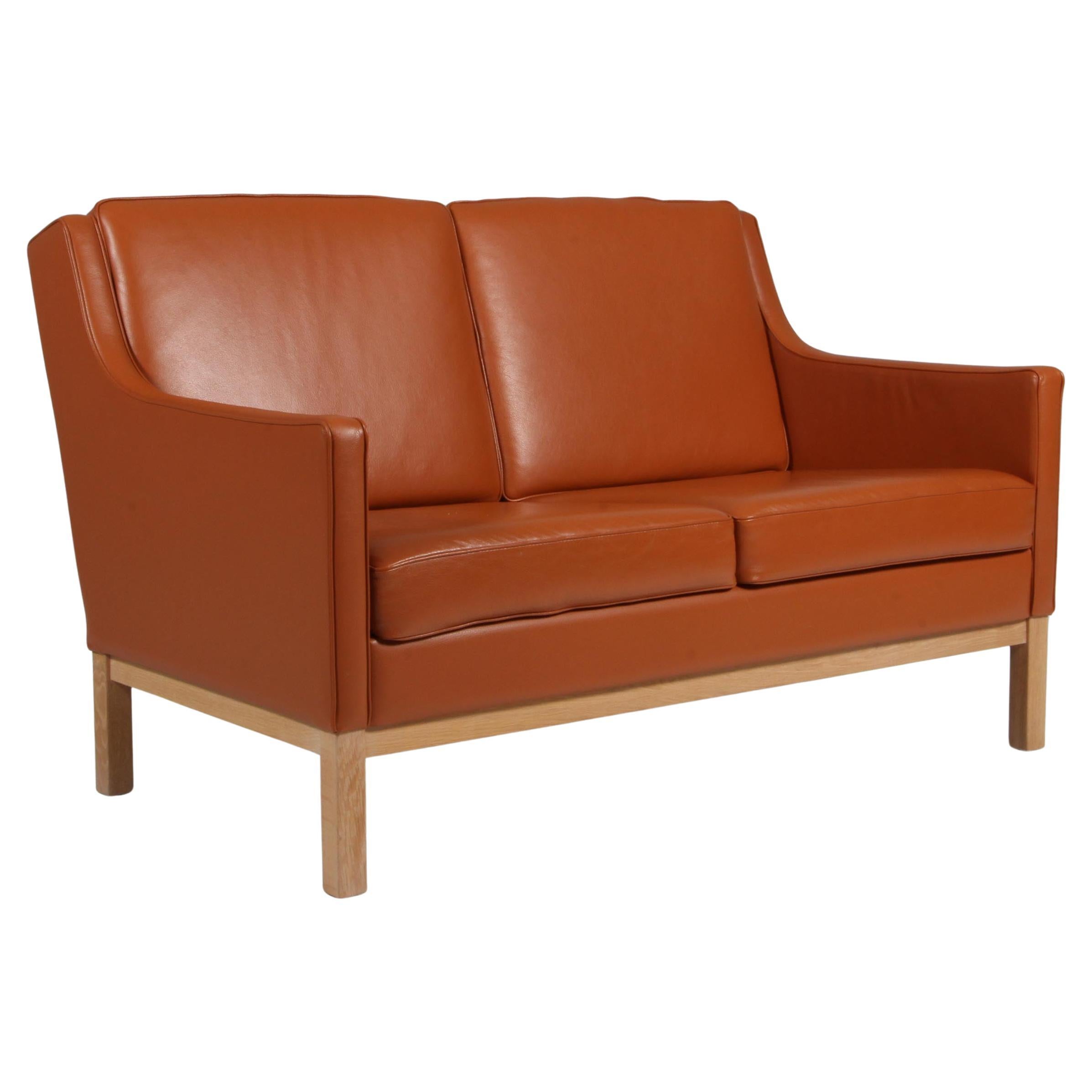 Erik Wørts two seat sofa, cognac leather, oak, Denmark For Sale