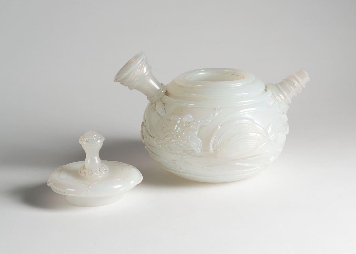 Provenance:
Archive of Cenedese Glassworks, Murano, Italy.

Ermanno Nason designed this beautiful teapot for Vetreria Gino Cenedese in 1964. It is composed of a milky, opaque glass, adorned with oriental motifs, and is well-balanced and playful,