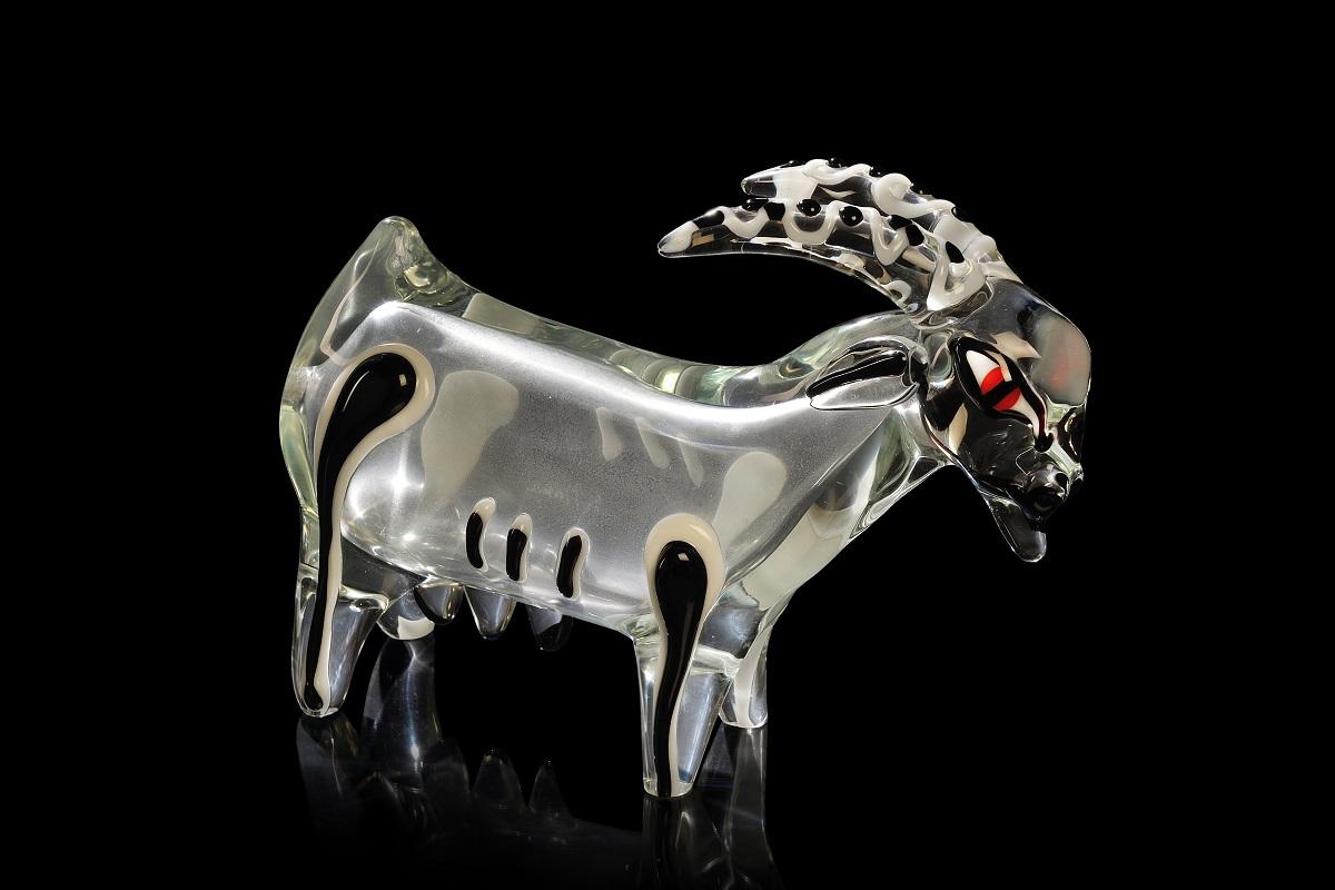 Ermanno Nason Murano Clear Glass Figure of a Goat with Applied Filaments

Offered for sale is a large sculpture of a goat made of thick transparent glass with applications of lattimo, black and red glass and slight iridescence, circa 1980. This