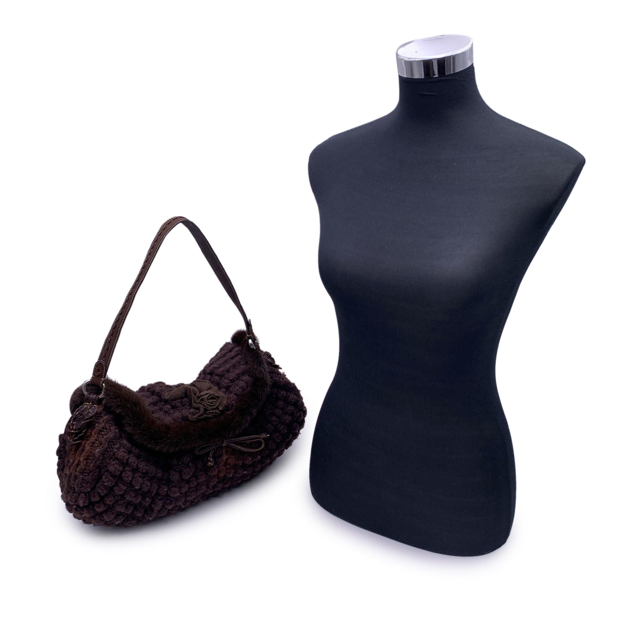 Ermanno Scervino brown wool knit tote bag. Fur trim and flower application on the front. Flap with self tie closure. Self-tie closure on top. Brown suede lining. 1 side zip pocket inside. 'Ermanno Scervino' tag inside. Condition B - VERY GOOD Gently