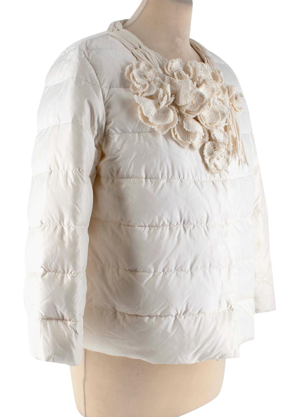 Ermanno Scervino Cream Floral Applique Collarless Puffer Jacket

- Textured floral embellishments around the neckline with stitched tassel design
- Warm mix of down and feather filling
- Light weight material
- Buttoned hidden fastening
- Round