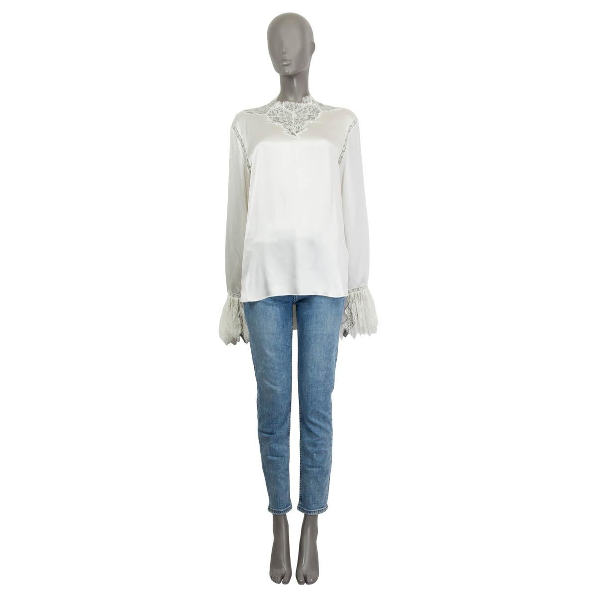 100% authentic Ermanno Scervino satin long sleeve blouse in ivory silk (100%). Embellished with lace details at the neck and ruched lace cuffs. Opens with three push buttons and six buttons on the back. Unlined. Has a barely visible small drawn