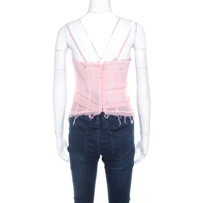 This close-fitting corset top coming from Ermanno Scervino is tailored into an alluring silhouette. Made from quality silk, this pink top has frayed details, ruffled trims, and zip closure.

Includes: Price Tag