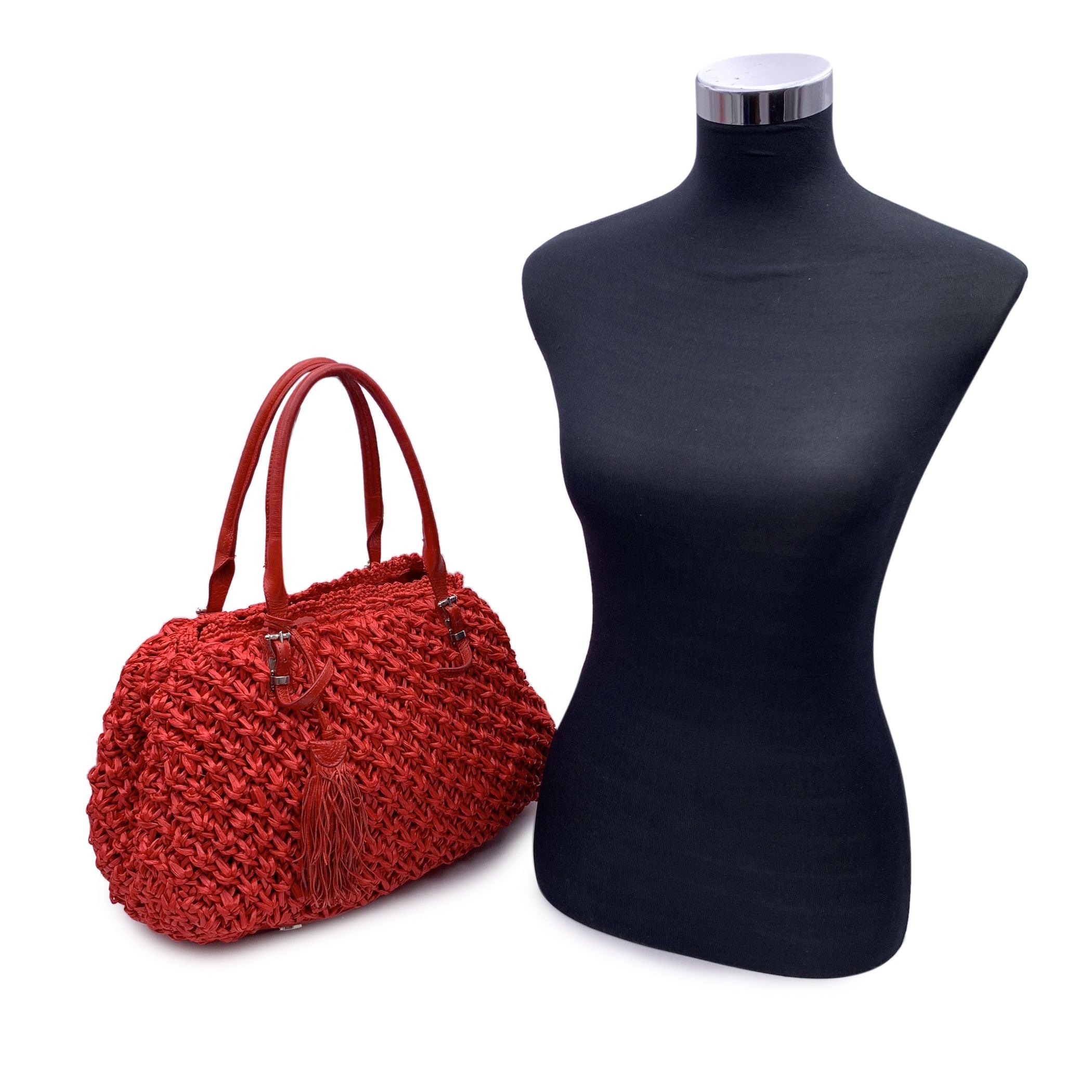Ermanno Scervino red raffia tote shoulder bag. Red leather parts and handles. Leather tassel detailing. Magnetic button closure. Fabric lining . 2 main sections with 1 middle zip compartment. 1 side zip pocket inside and 2 side open pockets inside.