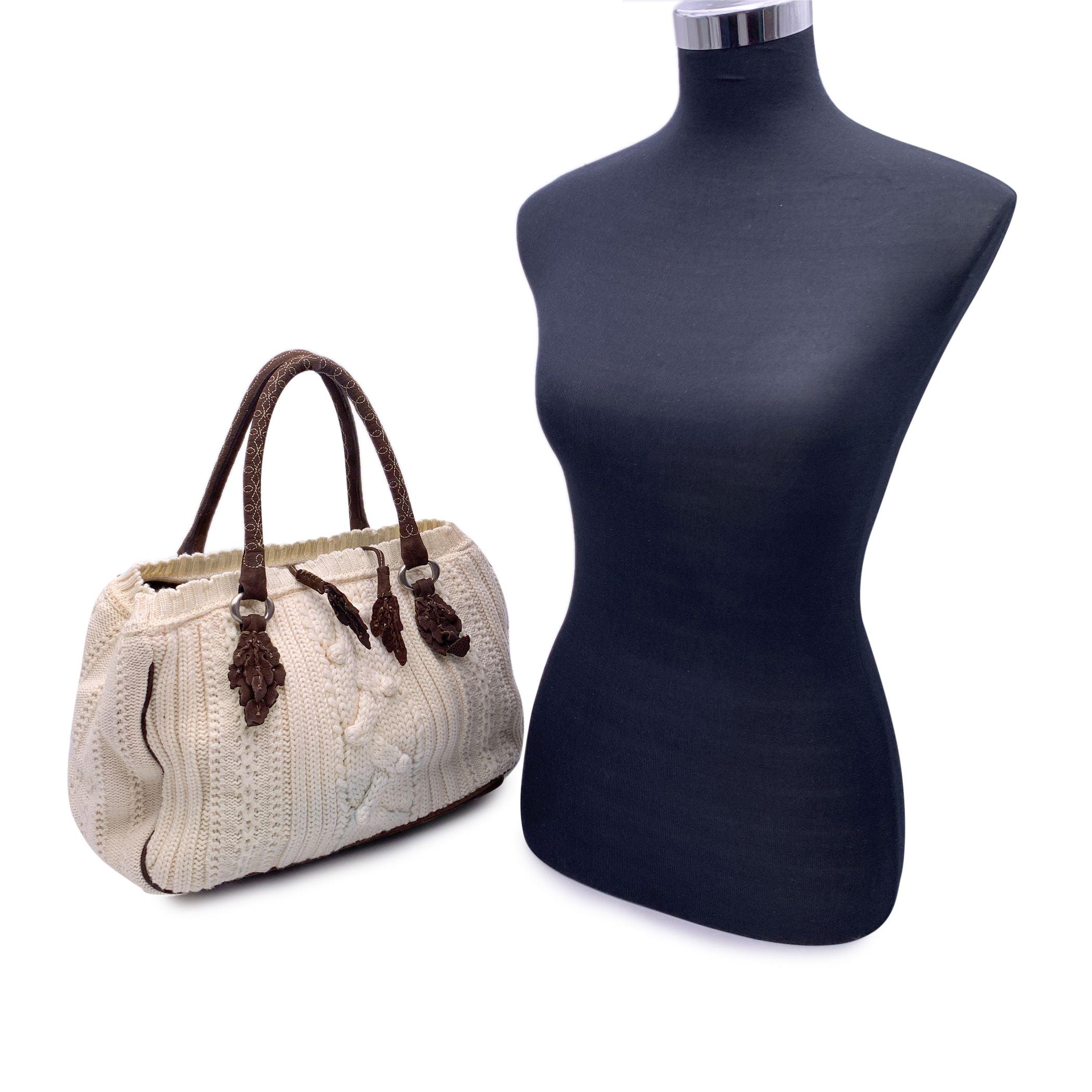 Ermanno Scervino white wool knit tote shoulder bag. Brown leather trim and handles. Contrast stitching. Self-tie closure on top. Brown suede lining. 2 main comaprtments and 1 middle zip section . 1 side zip pocket and 2 side open pockets inside.