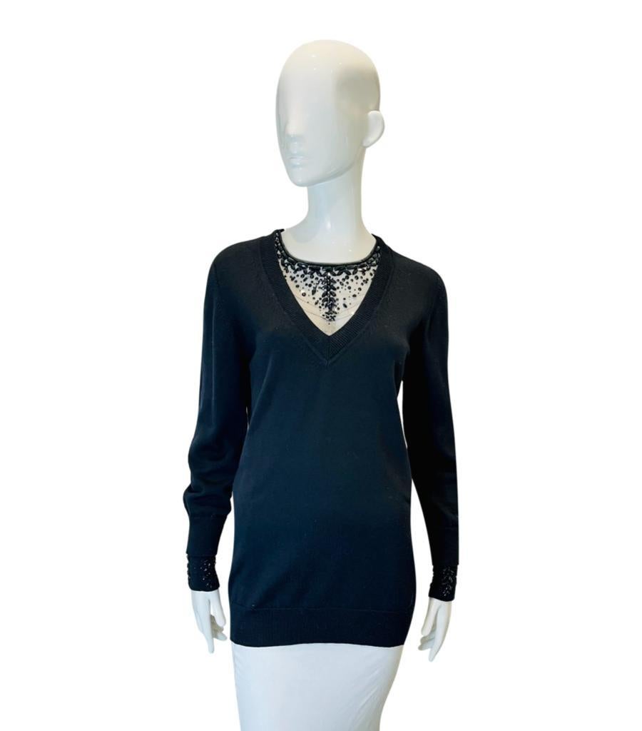 Ermanno Scervino Wool Jumper With Mesh Jewelled Neckline
Black longline knitwear designed with mesh detailed V-Neckline embellished with black beads.
Featuring long sleeves and ribbed edges.
Size – 44IT
Condition – Very Good
Composition – 100% Wool
