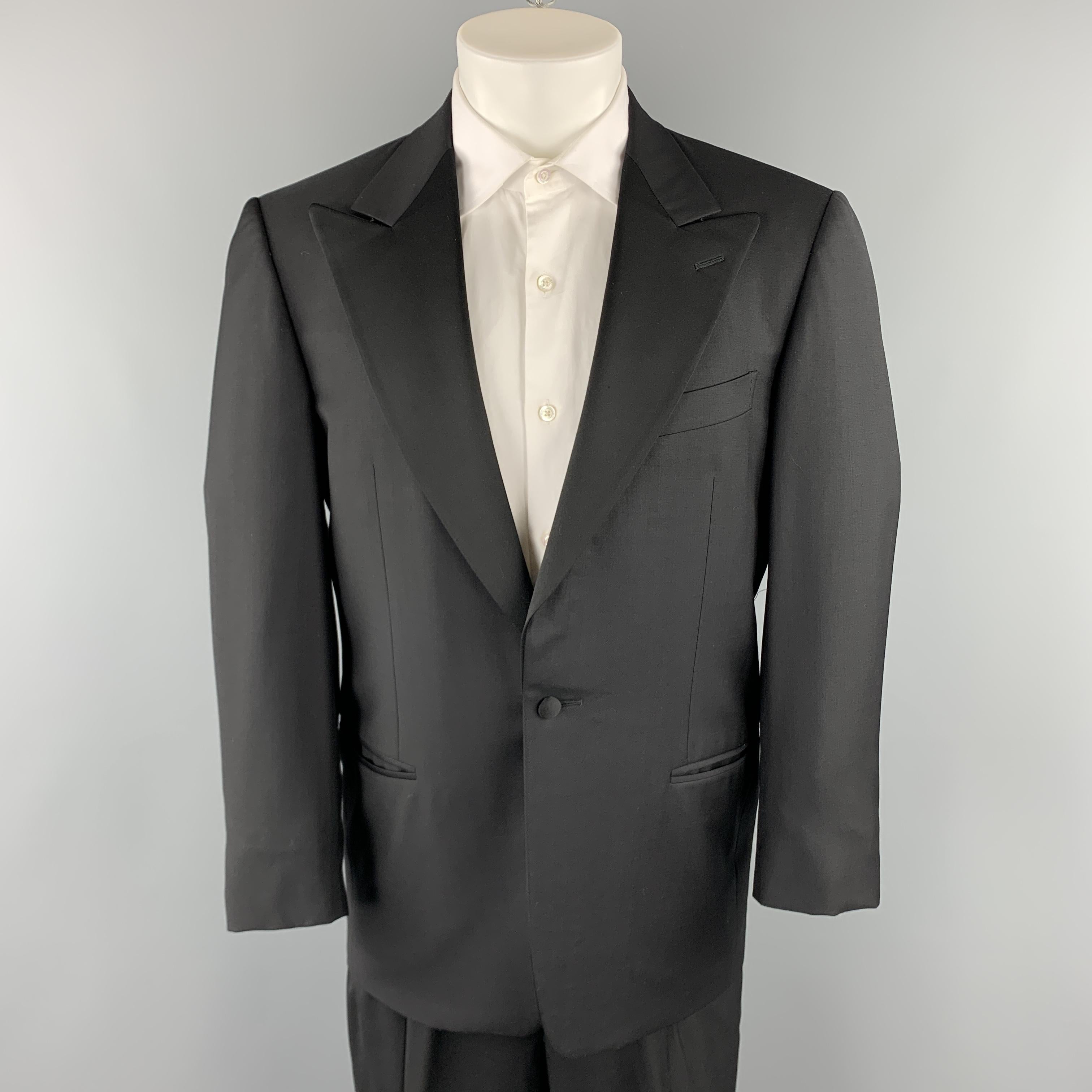 ERMENEGILDO ZEGNA short tuxedo suit comes in a black wool material and includes a single breasted, one button sport coat with a peak lapel and matching pleated front trousers. Made in Italy. 

Excellent Pre-Owned Condition.
Marked: Jacket IT 48,
