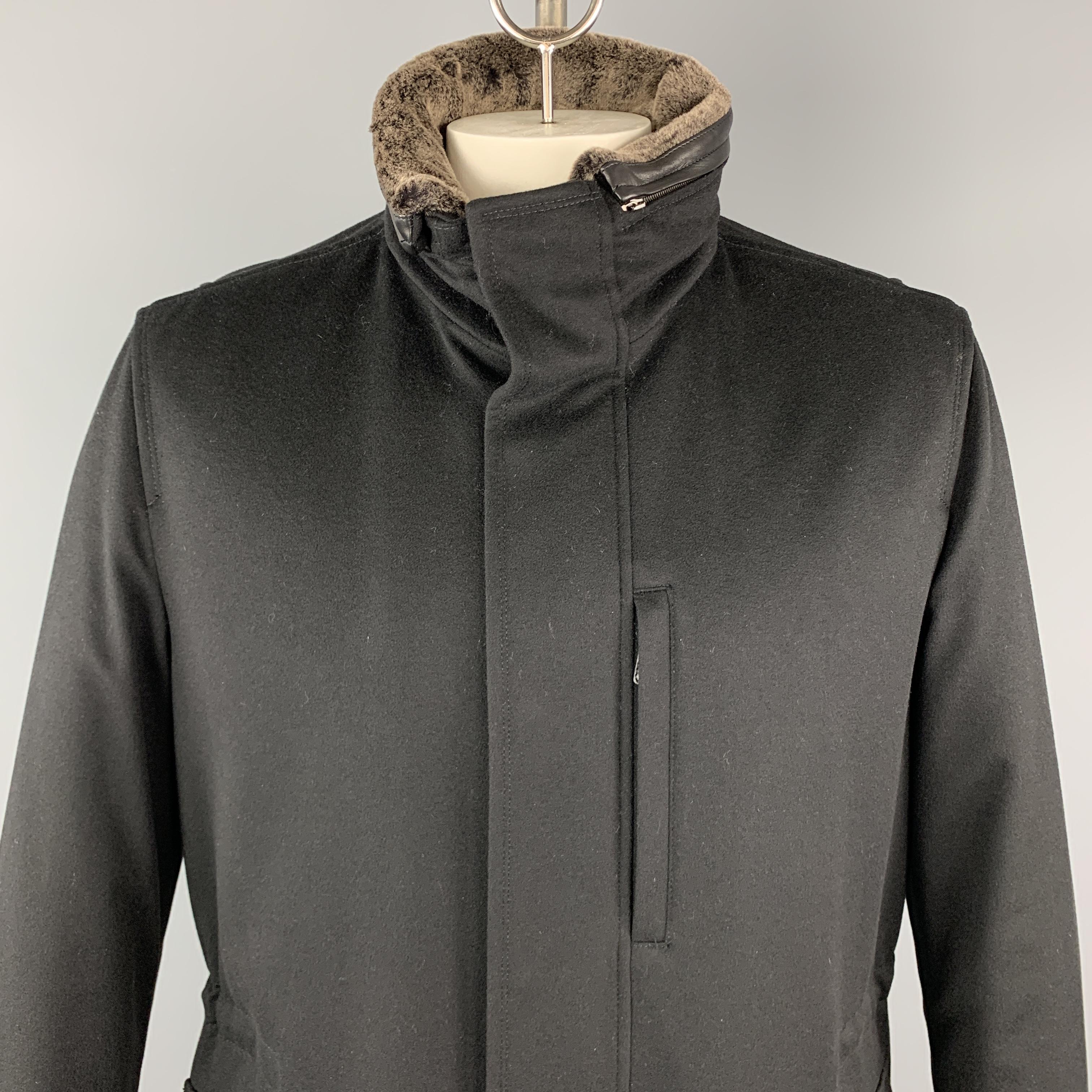 ERMENEGILDO ZEGNA coat comes in black cashmere with a zip front, hidden snap placket, drawstring waist, flap and zip pockets, and optional faux fur collar or hood. Made in Portugal.

New with Tags. 
Marked: IT 50

Measurements:

Shoulder: 19