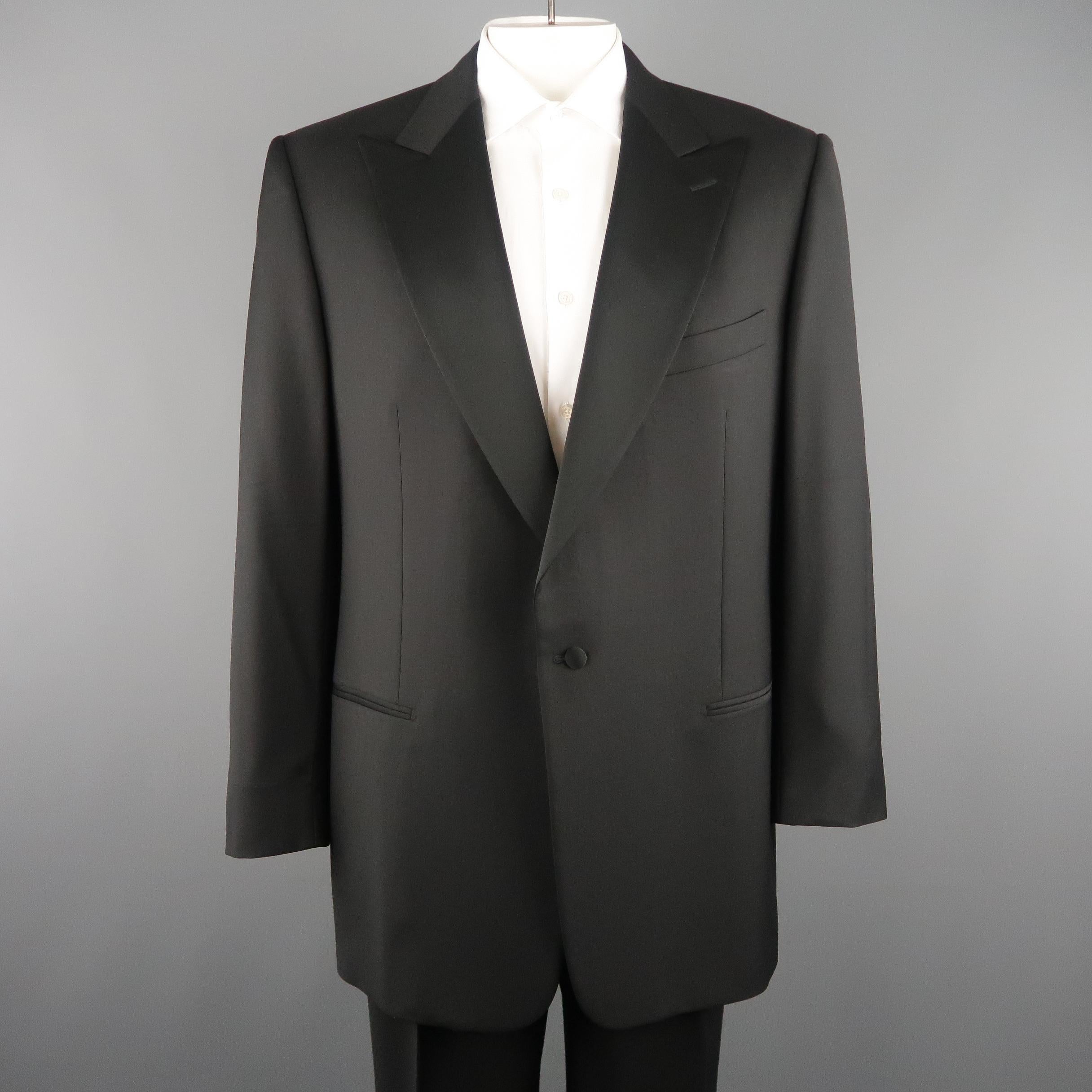 ERMENEGILDO ZEGNA tuxedo suit comes in black wool and includes a single button sport jacket with a satin peak lapel and matching tuxedo stripe pleated trousers. Made in Switzerland.
 
Excellent Pre-Owned Condition.
Marked: IT 58
 
Measurements:
