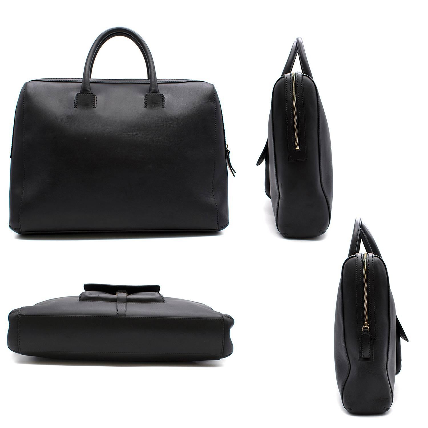 Ermenegildo Zegna black calf leather large bag. 

Features small pocket on front of the bag.
Includes a small interior pocket and two pouches. 
Includes zip closure. 

Fabric: Calf leather
Measurements:  Approx: Handle Drop- 11cm Length- 44cm