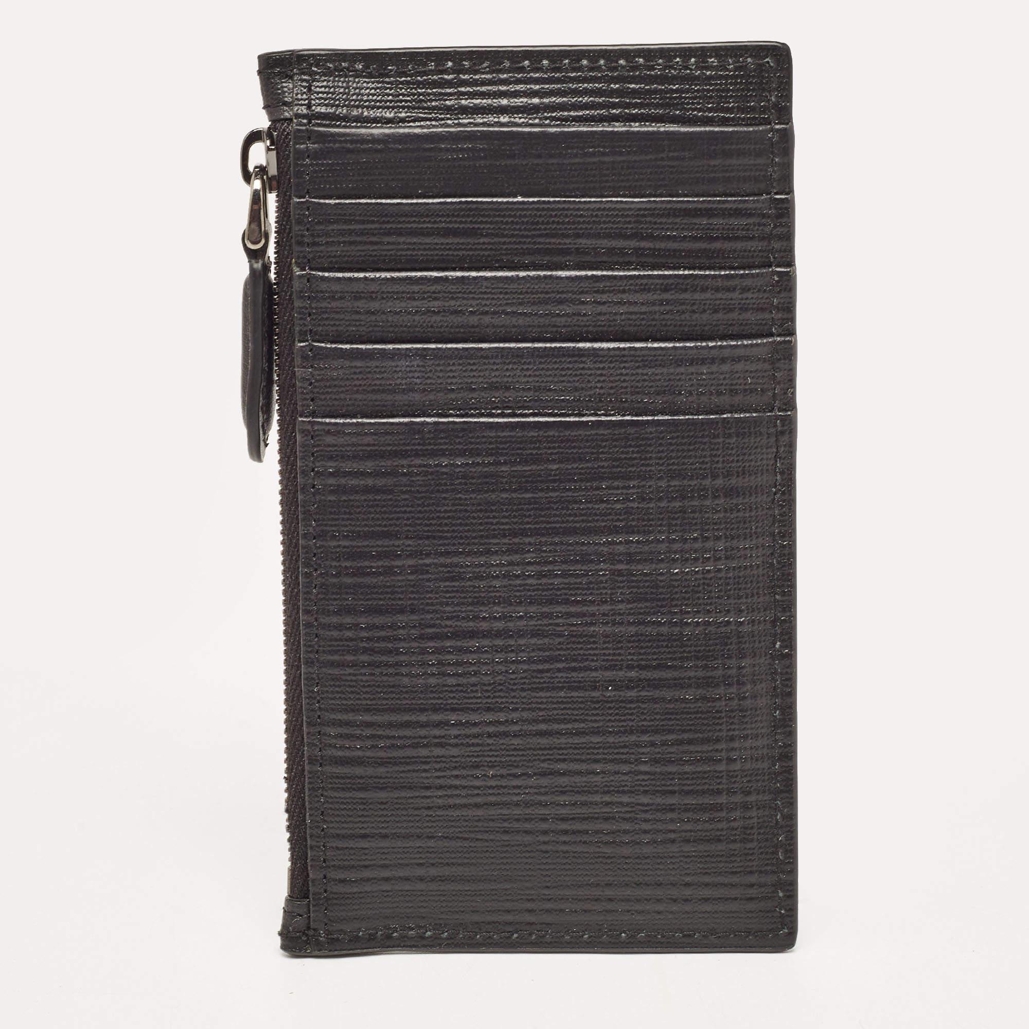 This sleek and functional case from Ermenegildo Zegna is crafted with leather carrying a black hue. The case comes with multiple card slots and a zipped compartment. Its slender shape makes it easily slip into your pocket.

Includes: Original Box,