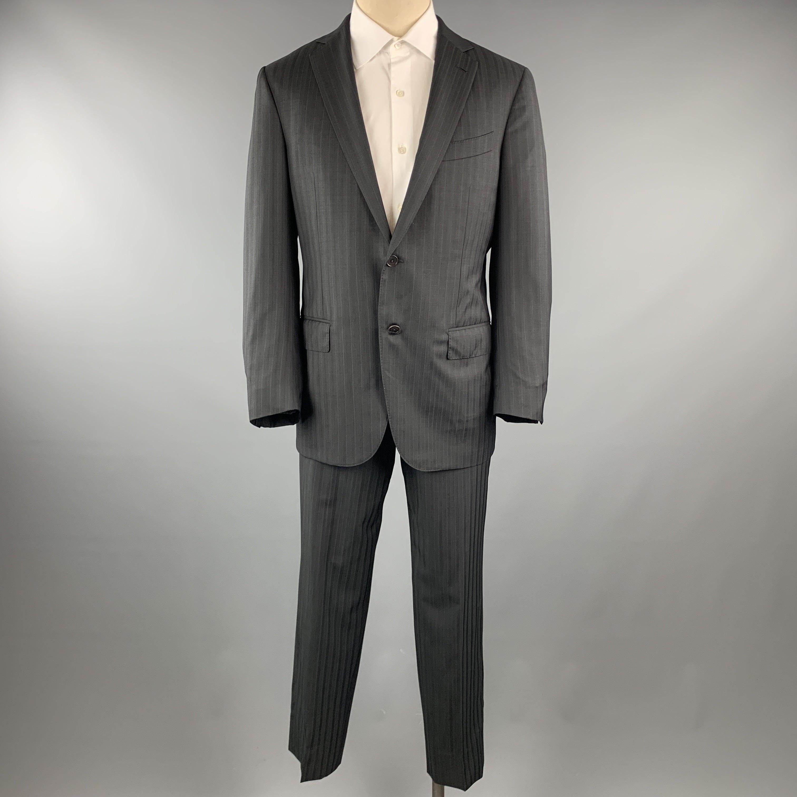 ERMENEGILDO ZEGNA
suit comes in a black stripe wool and includes a single breasted, two button sport coat with a notch lapel and matching front trousers. Made in Italy.Excellent Pre-Owned Condition. 

Marked:   50 

Measurements: 
  -JacketShoulder: