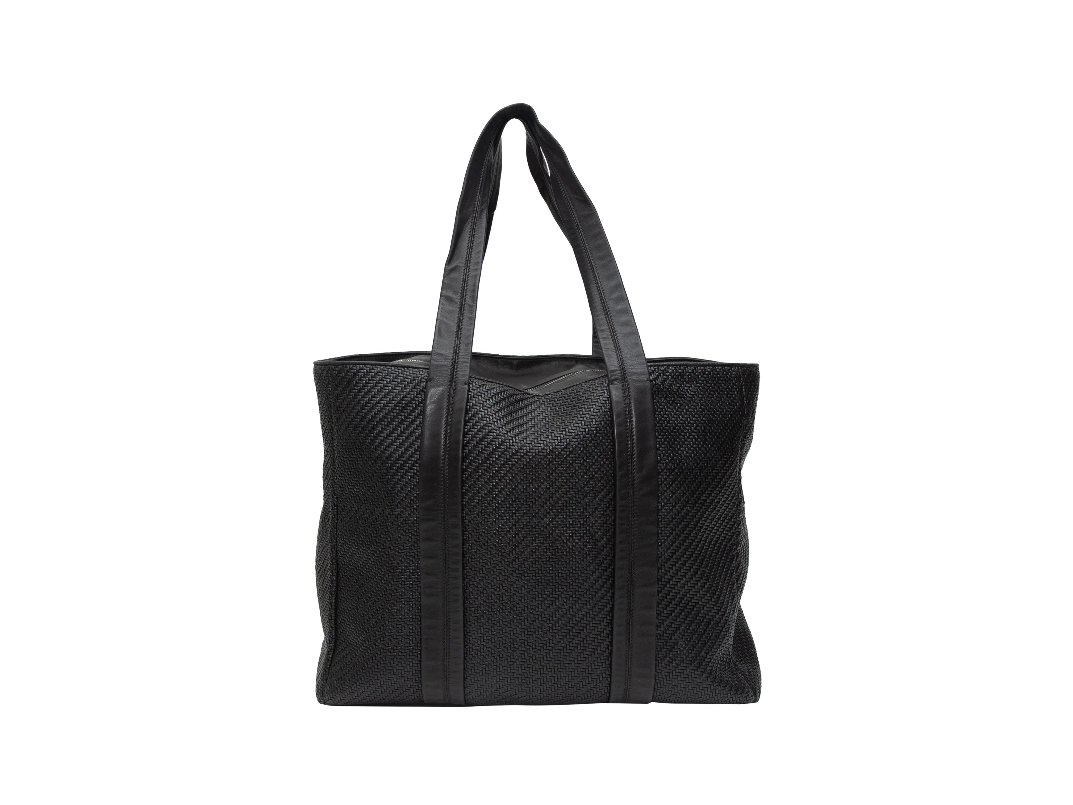 Product details: Black woven leather tote bag by Ermenegildo Zegna. Dual flat top handles. Zip closure at top. 18