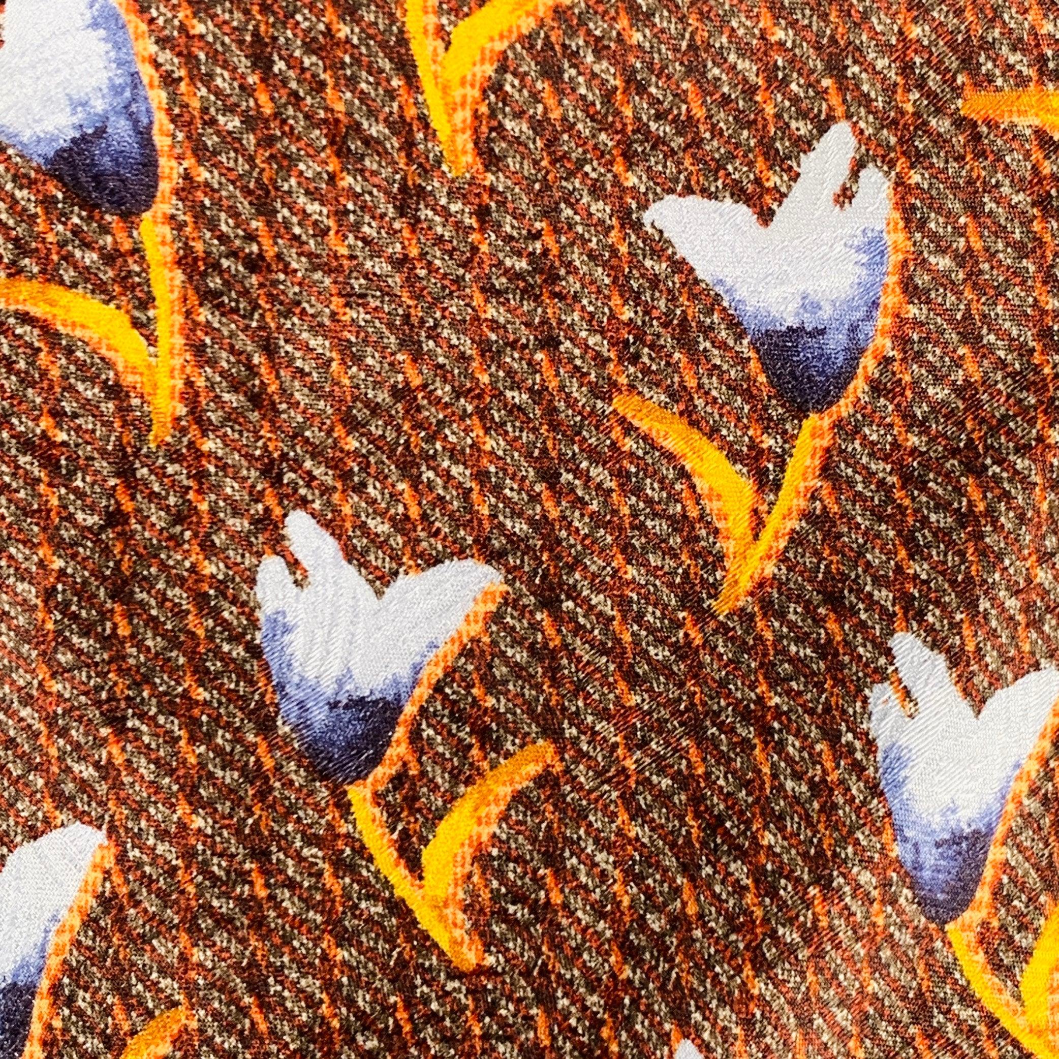 ERMENEGILDO ZEGNA necktie in a brown silk featuring a blue abstract floral watercolor design. Made in Italy.Very Good Pre-Owned Condition. 

Measurements: 
  Width: 3.75 inches Length: 59 inches 

  
  
 
Sui Generis Reference: 135302
Category: