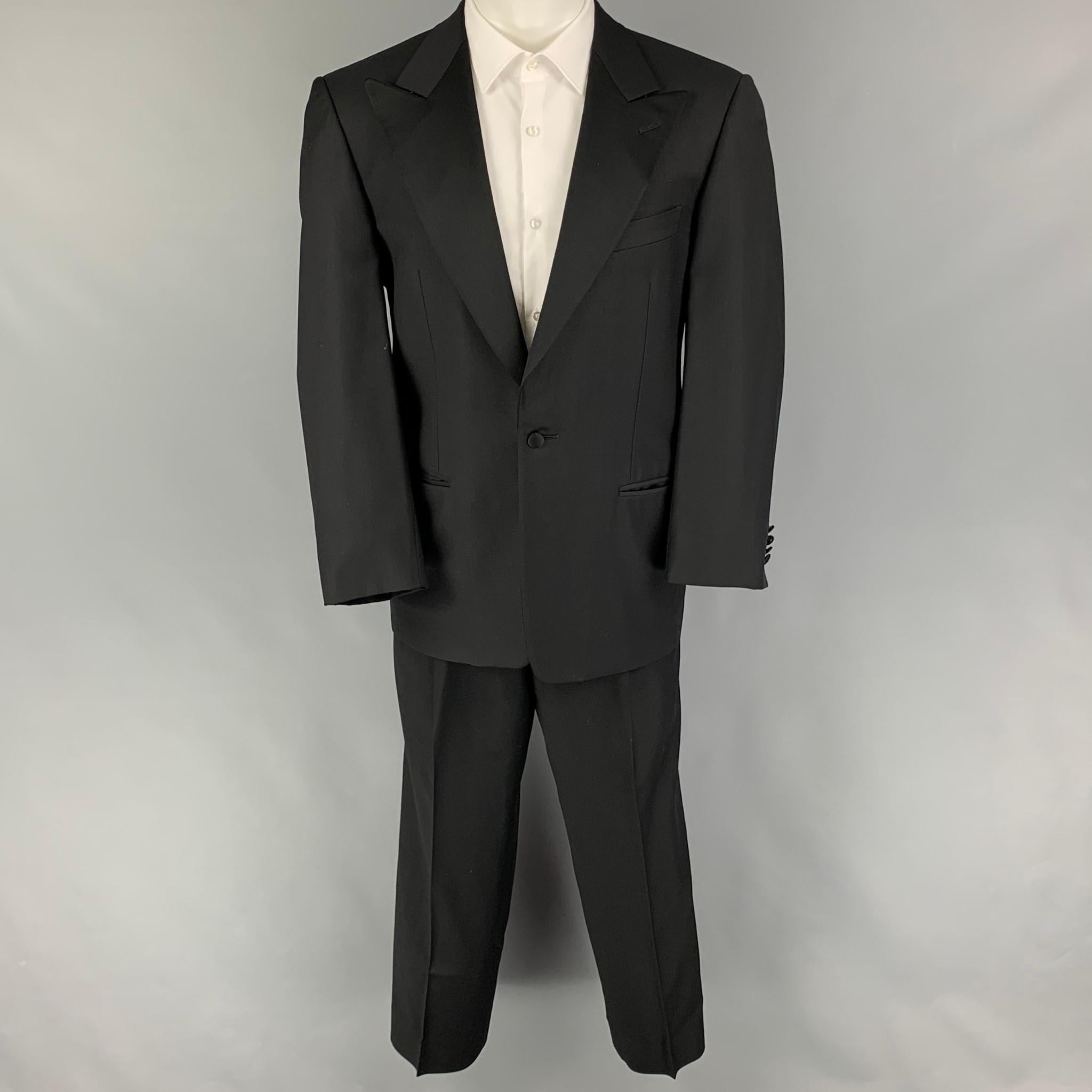 ERMENEGILDO ZEGNA for Neiman Marcus suit comes in a black wool with a full liner and includes a single breasted, single button sport coat with a peak lapel and matching pleated front trousers.

Good Pre-Owned Condition.
Marked: