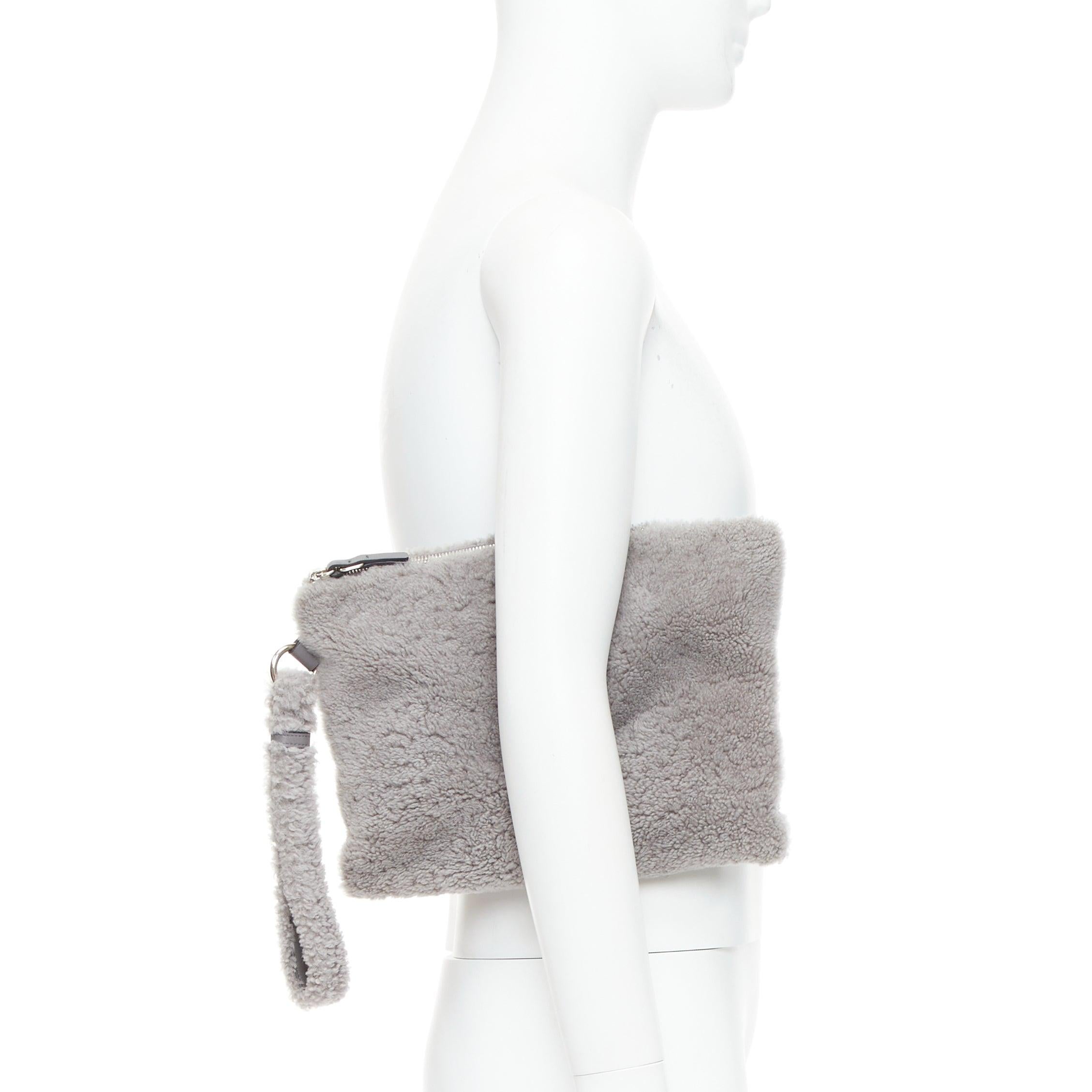 ERMENEGILDO ZEGNA grey lambskin shearling wrist strap zip clutch bag
Reference: PRCG/A00083
Brand: Ermenegildo Zegna
Material: Shearling
Color: Grey
Pattern: Solid
Closure: Zip
Lining: Black Fabric
Extra Details: Detachable wrist