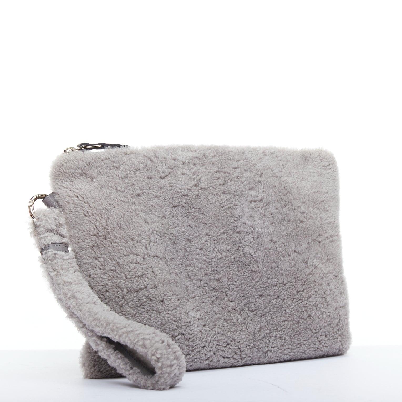 Gray ERMENEGILDO ZEGNA grey lambskin shearling wrist strap zip clutch bag For Sale