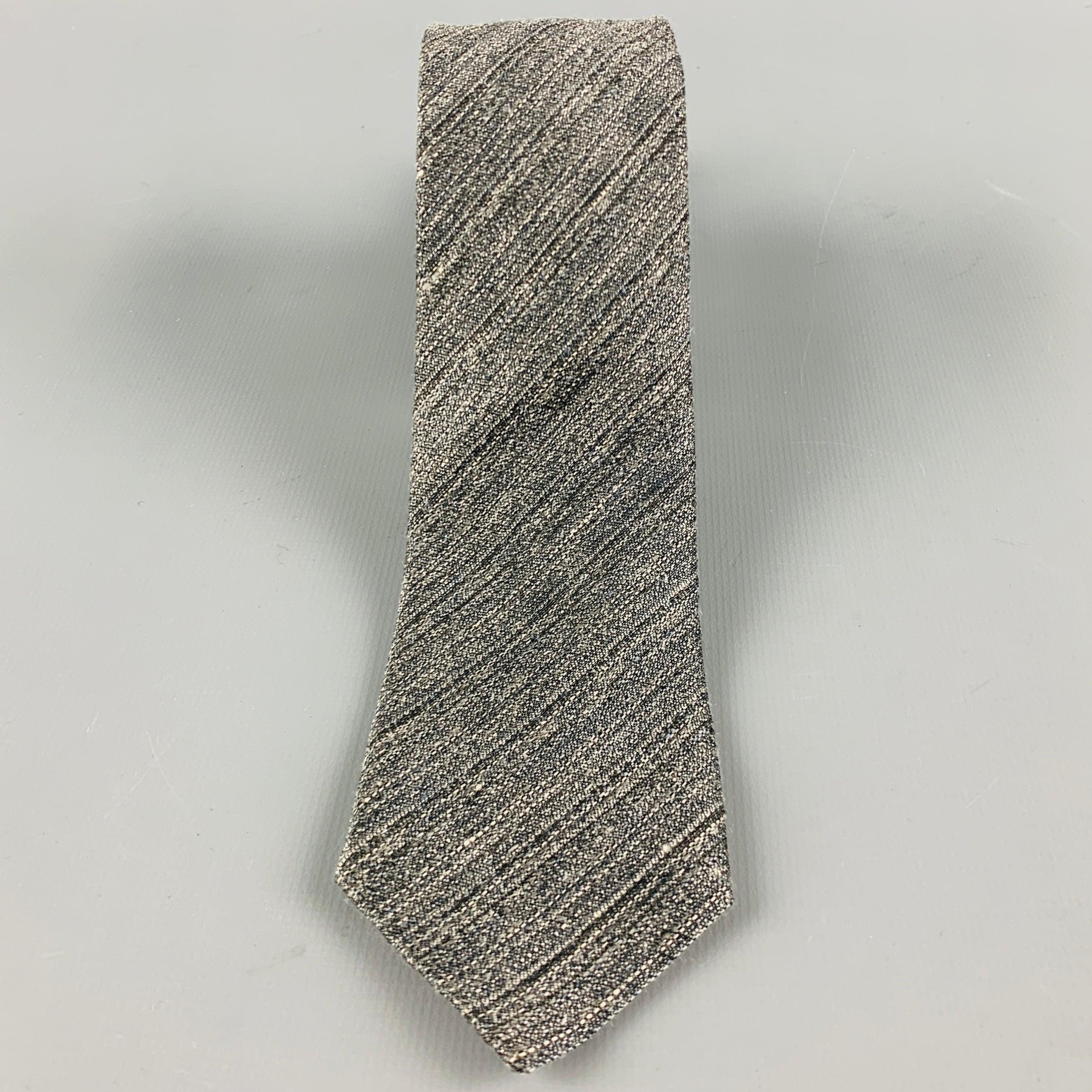 ERMENEGILDO ZEGNA
necktie in a
grey and white linen silk blend fabric featuring a diagonal stripe pattern and skinny style. Made in Italy.Excellent Pre-Owned Condition. 

Measurements: 
  Width: 2 inches Length: 60 inches 
  
  
 
Reference No.: