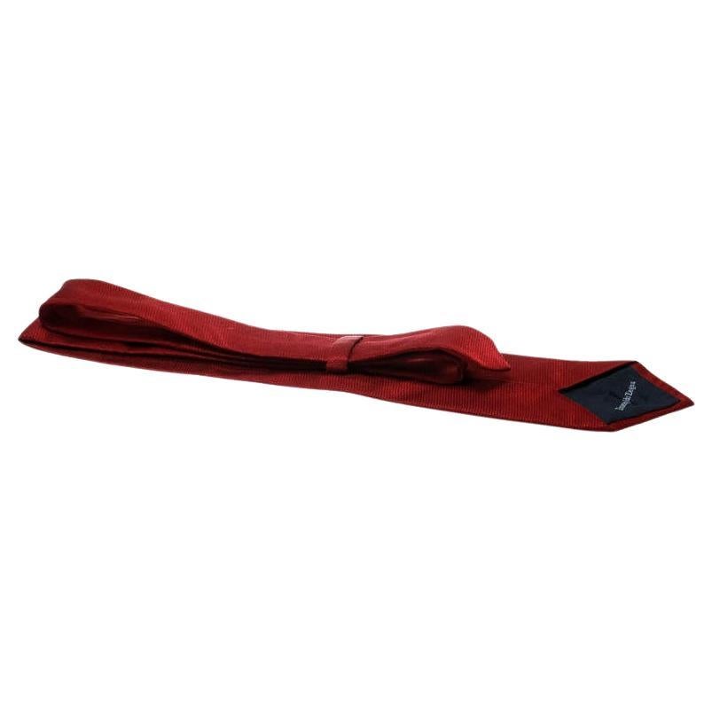 This red tie from Ermenegildo Zegna is sure to make you look suave, smart and very handsome! The tie is made of a silk and cotton blend and features a textured jacquard pattern. It comes with a penny keeper strap at the back and is ideal for the