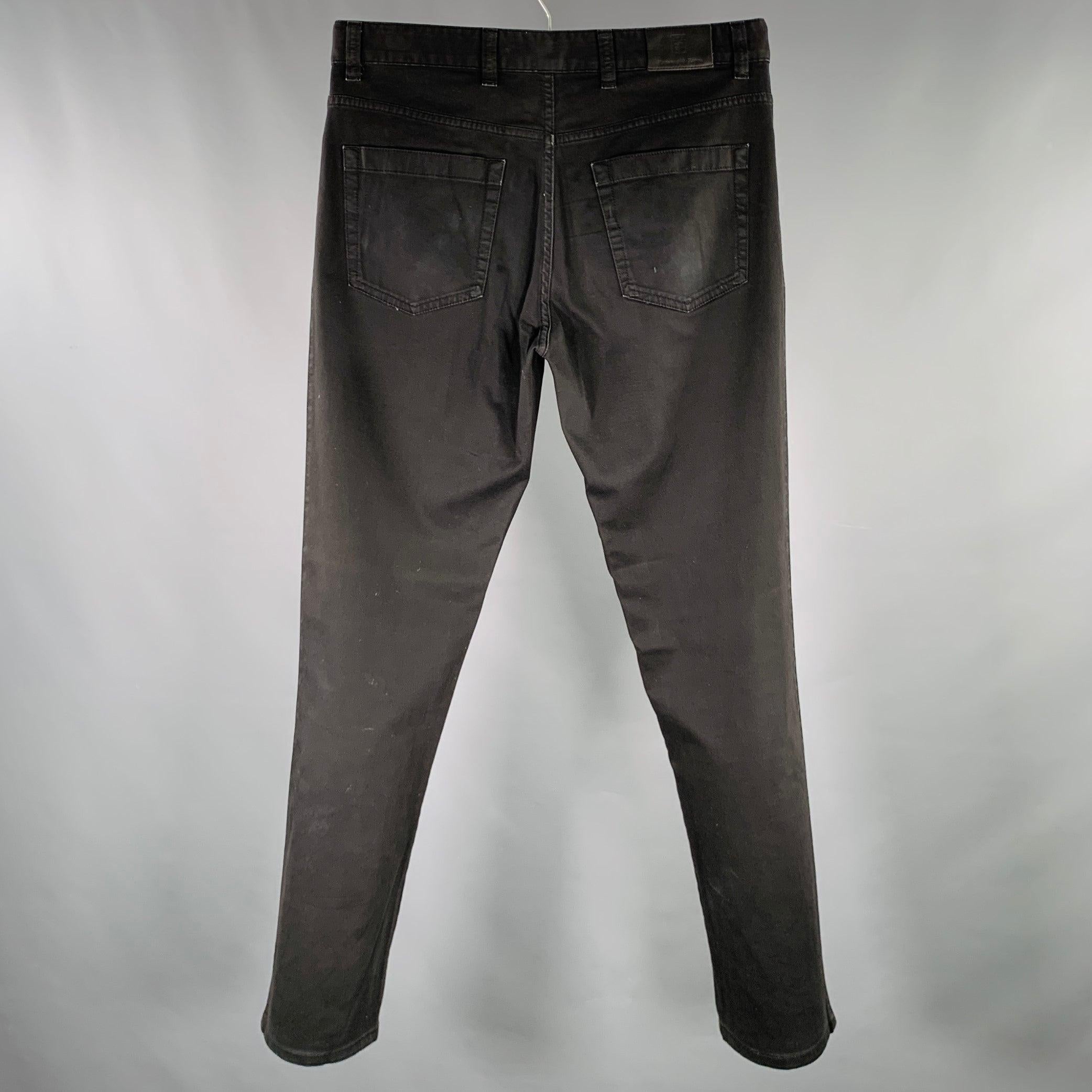 ERMENEGILDO ZEGNA jeans in a black cotton stretch blend fabric featuring a five pockets style, straight leg, and zip fly closure. Made in Romania.Good Pre-Owned Condition. Moderate fading and signs of wear. 

Marked:   32 

Measurements: 
  Waist: