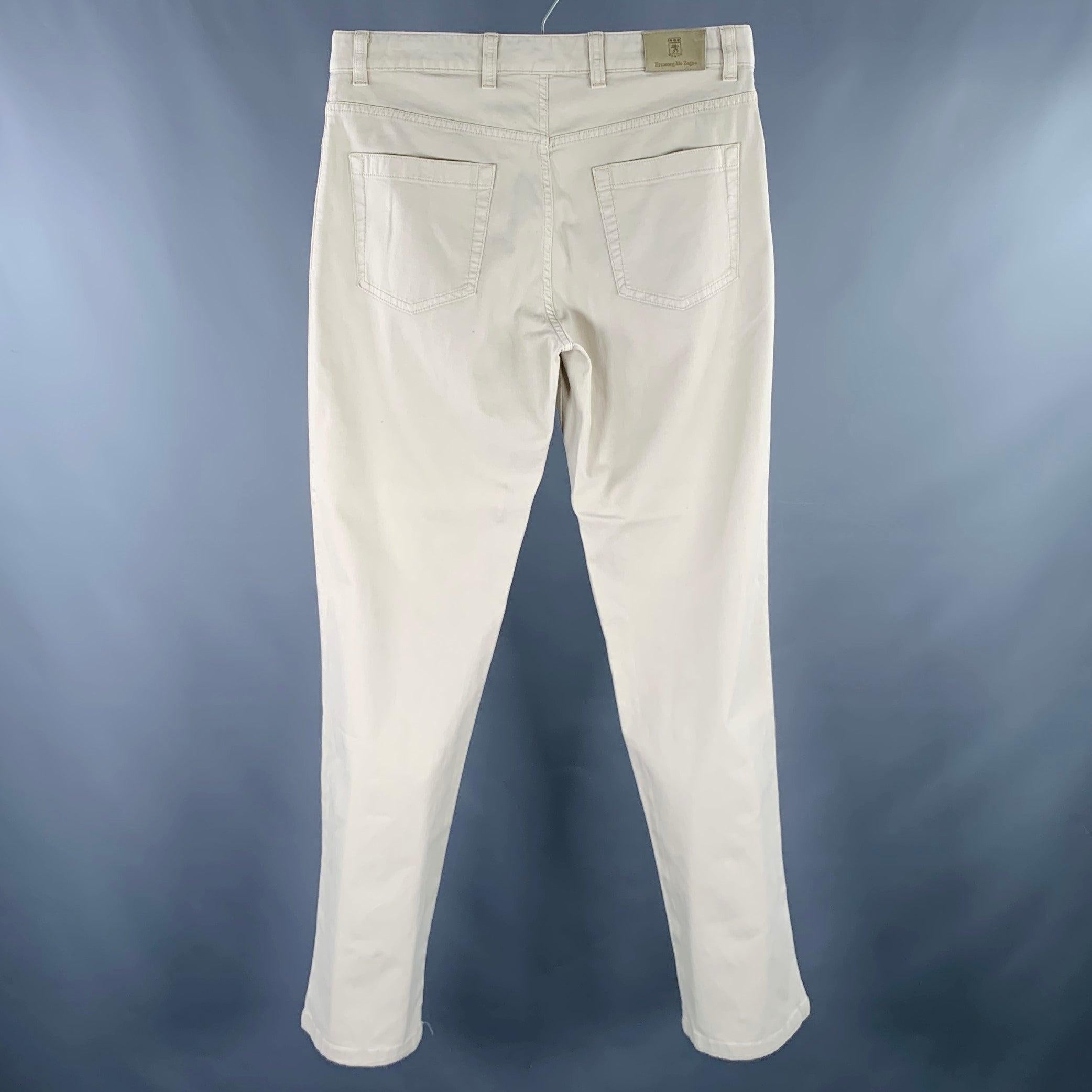 ERMENEGILDO ZEGNA jeans in a beige cotton stretch blend fabric featuring a five pockets style, straight leg, and zip fly closure. Made in Romania.Excellent Pre-Owned Condition. 

Marked:   33 

Measurements: 
  Waist: 33 inches Rise: 9 inches