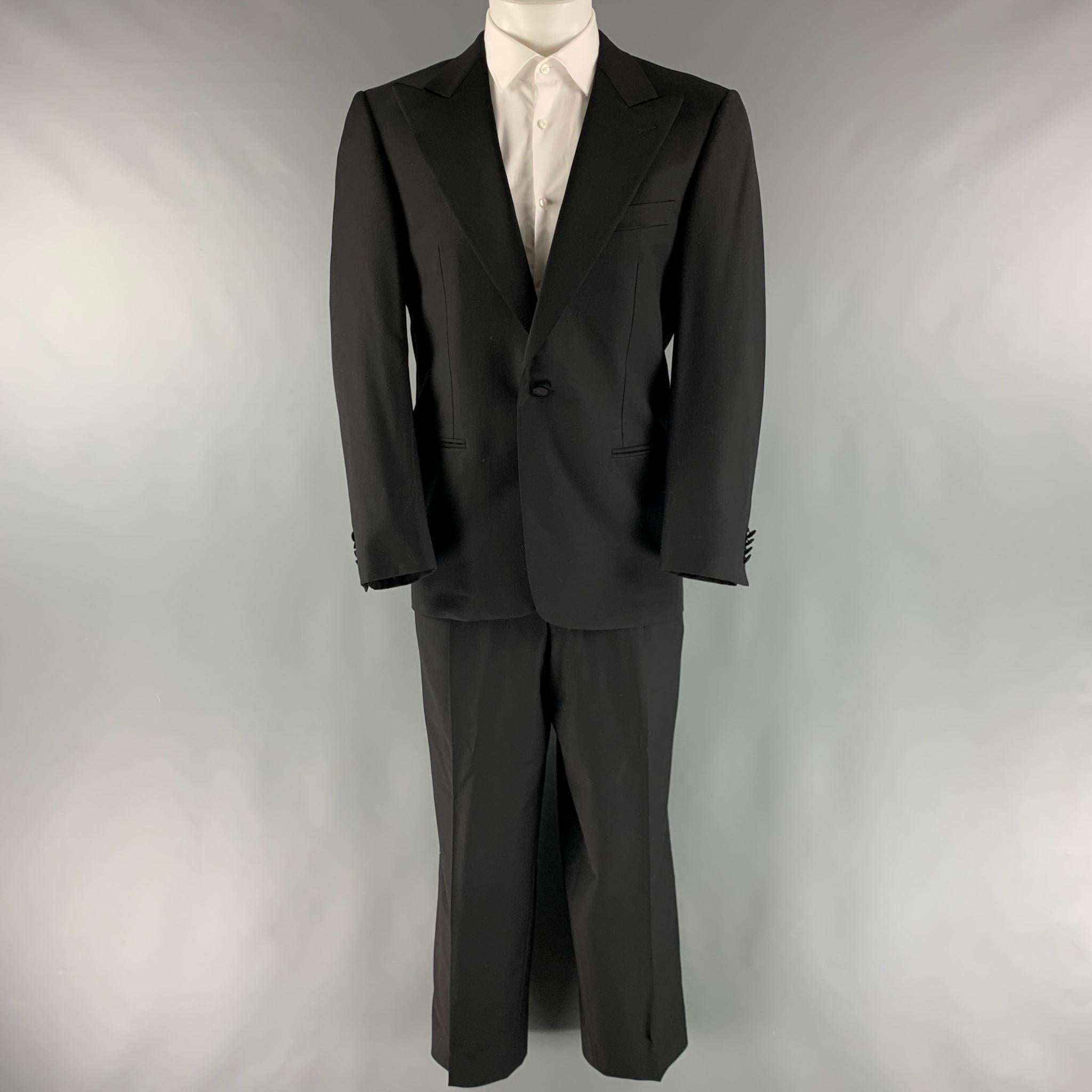 ERMENEGILDO ZEGNA for Neiman Marcus tuxedo comes in a black wool with a full liner and includes a single breasted, single button sport coat with a peak lapel and matching pleated front trousers. Made in Switzerland.

Excellent Pre-Owned