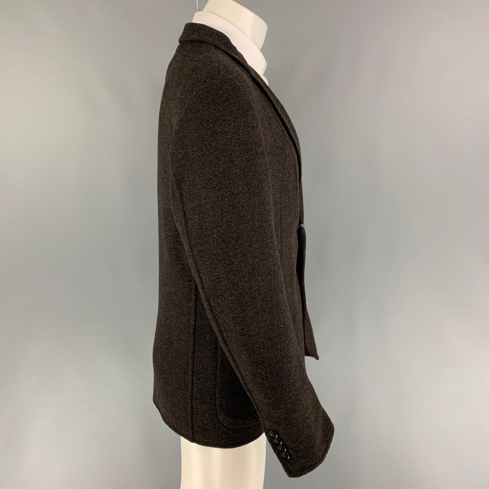 ERMENEGILDO ZEGNA sport coat comes in a brown & black herringbone wool blend featuring a notch lapel, patch pockets, single back vent, and a double button closure. 

New With Tags. 
Marked: 50

Measurements:

Shoulder: 18 in.
Chest: 40 in.
Sleeve: