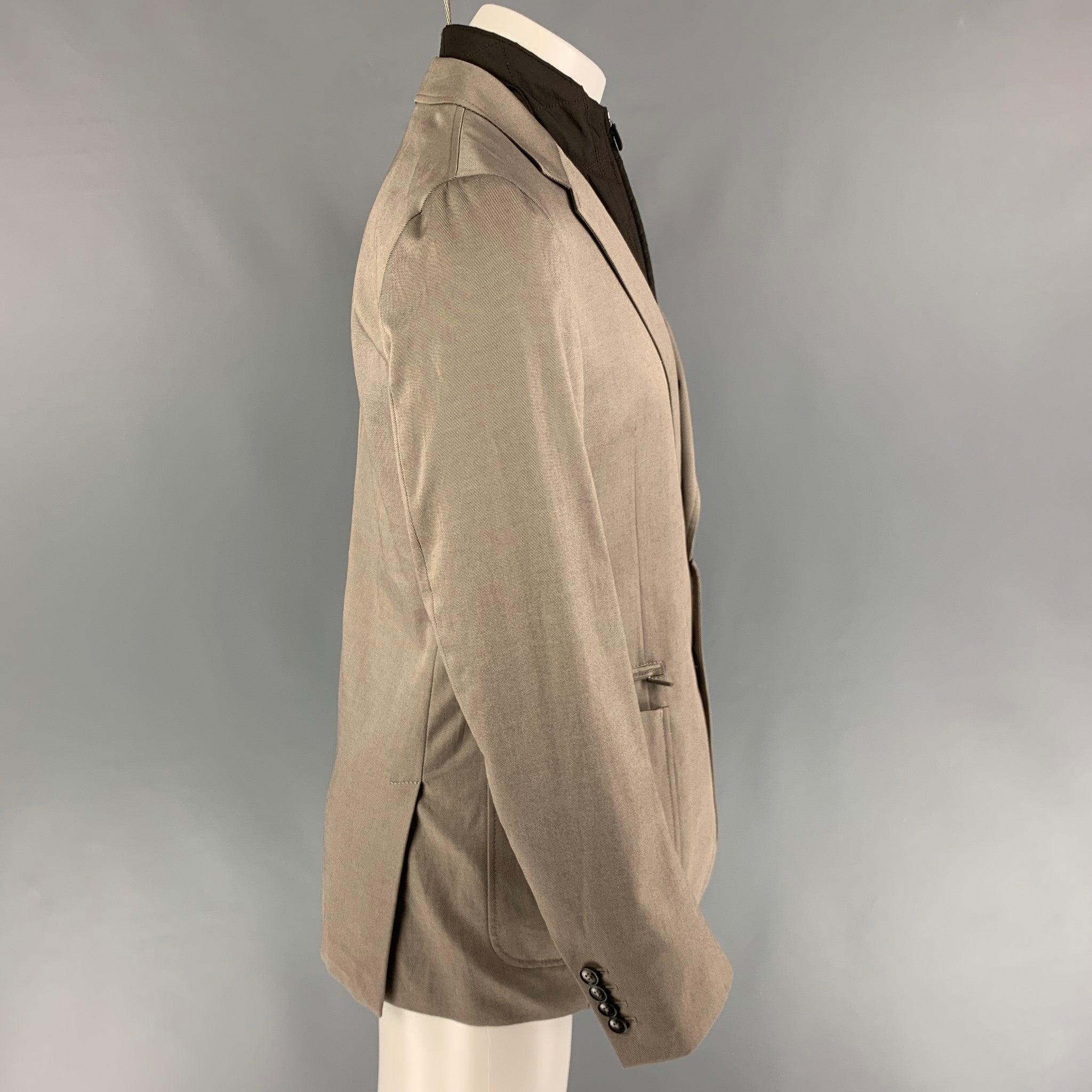 ERMENEGILDO ZEGNA sport coat comes in a khaki cotton / cashmere featuring a detachable vest panel, notch lapel, patch pockets, and a double button closure.
New With Tags. 

Marked:   50 

Measurements: 
 
Shoulder: 18 inches  Chest:
40 inches 