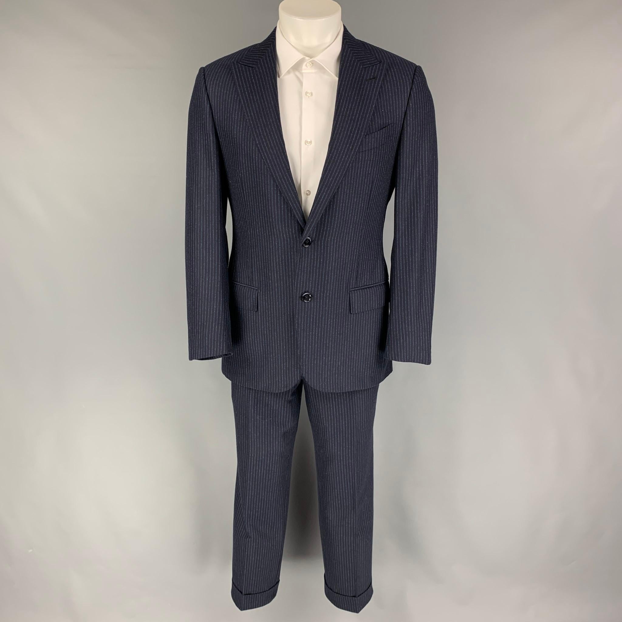 ERMENEGILDO ZEGNA suit comes in a navy & blue chalk stripe wool / cashmere with full liner and includes a single breasted, two button sport coat with a peak lapel and matching flat front trousers. Made in Italy.

Excellent Pre-Owned