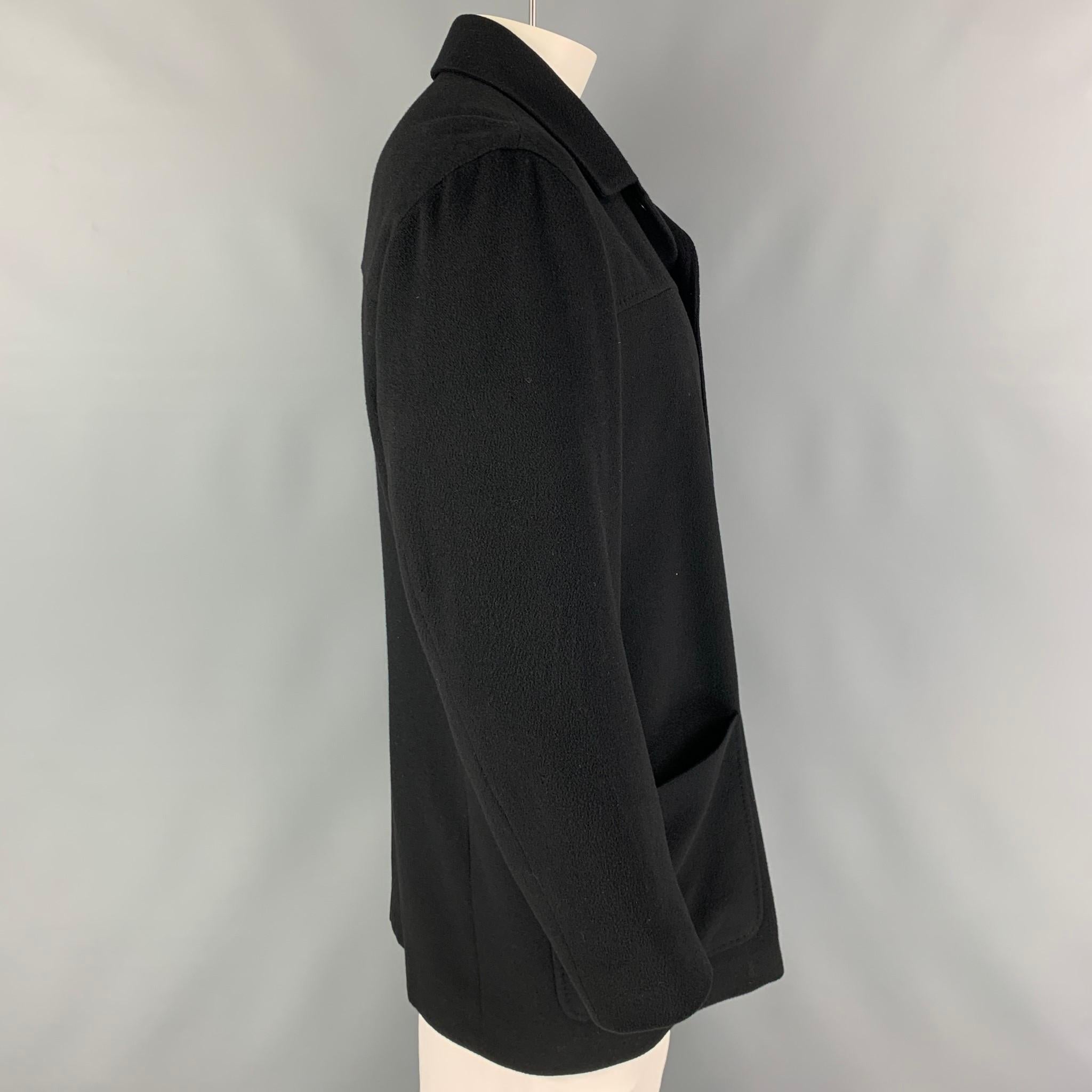 ERMENEGILDO ZEGNA jacket comes in a black cashmere with a full liner featuring a spread collar, patch pockets, and a buttoned closure. Made in Italy. 

Very Good Pre-Owned Condition.
Marked: L/52

Measurements:

Shoulder: 21 in.
Chest: 44