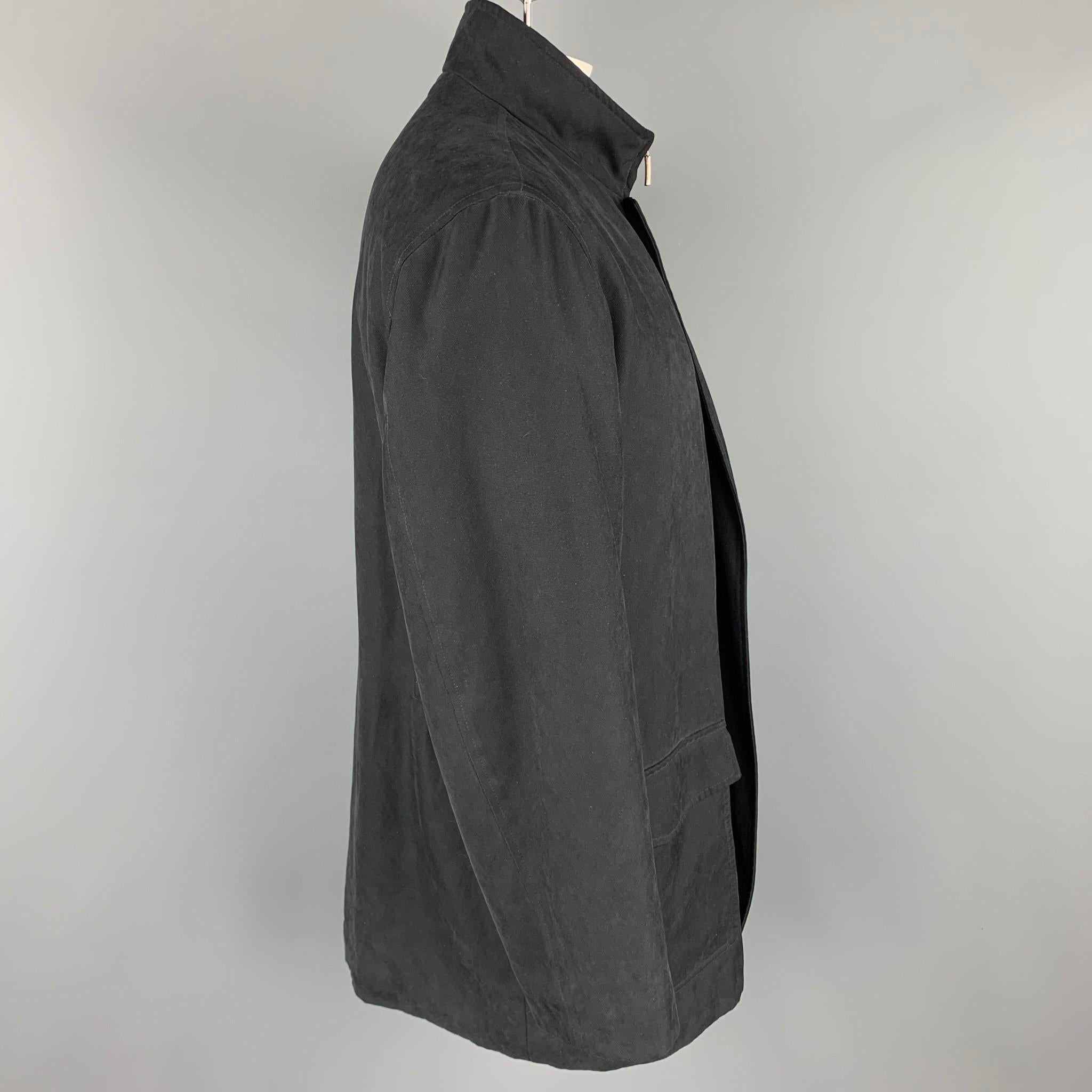 ERMENEGILDO ZEGNA coat comes in a black polyester blend with a quilted liner featuring flap pockets and a hidden zip up closure. Made in Italy. 

Very Good Pre-Owned Condition.
Marked: L/52

Measurements:

Shoulder: 21 in.
Chest: 48 in.
Sleeve: 26