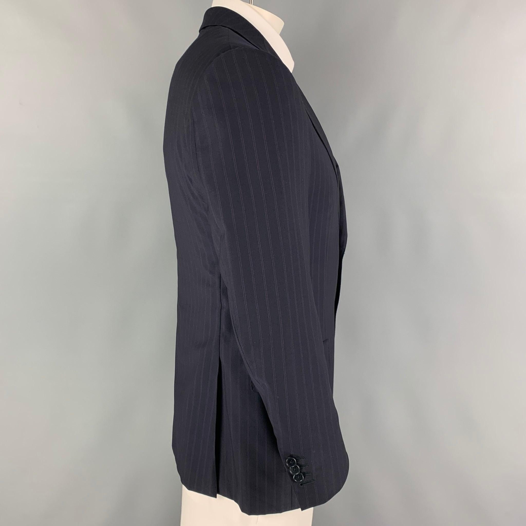 ERMENEGILDO ZEGNA sport coat comes in a black & purple stripe wool / silk with a full liner featuring a notch lapel, flap pockets, double back vent, and a double button closure.
Excellent
Pre-Owned Condition. 

Marked:   52 C  

Measurements: 
