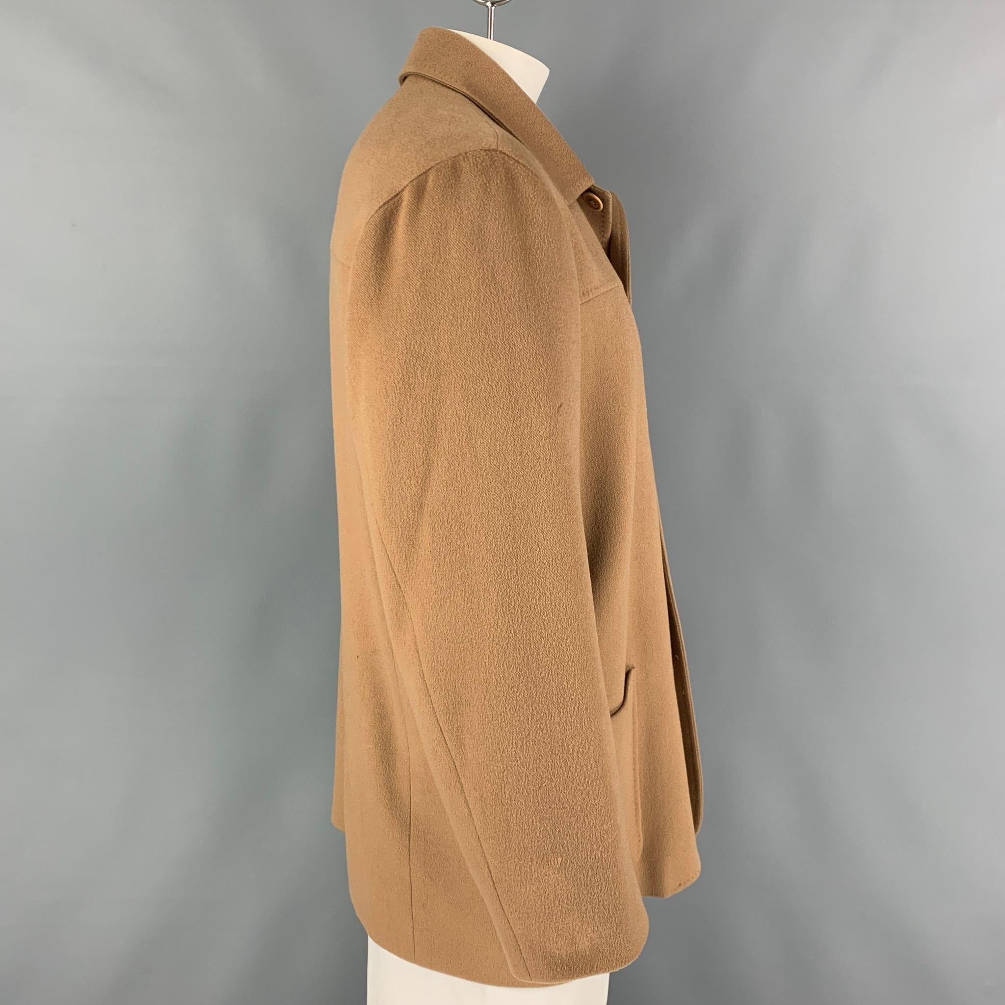 ERMENEGILDO ZEGNA jacket comes in a camel cashmere with a full liner featuring a spread collar, patch pockets, and a buttoned closure. Made in Italy.

Very Good Pre-Owned Condition.
Marked: L/52

Measurements:

Shoulder: 21 in.
Chest: 44 in.
Sleeve: