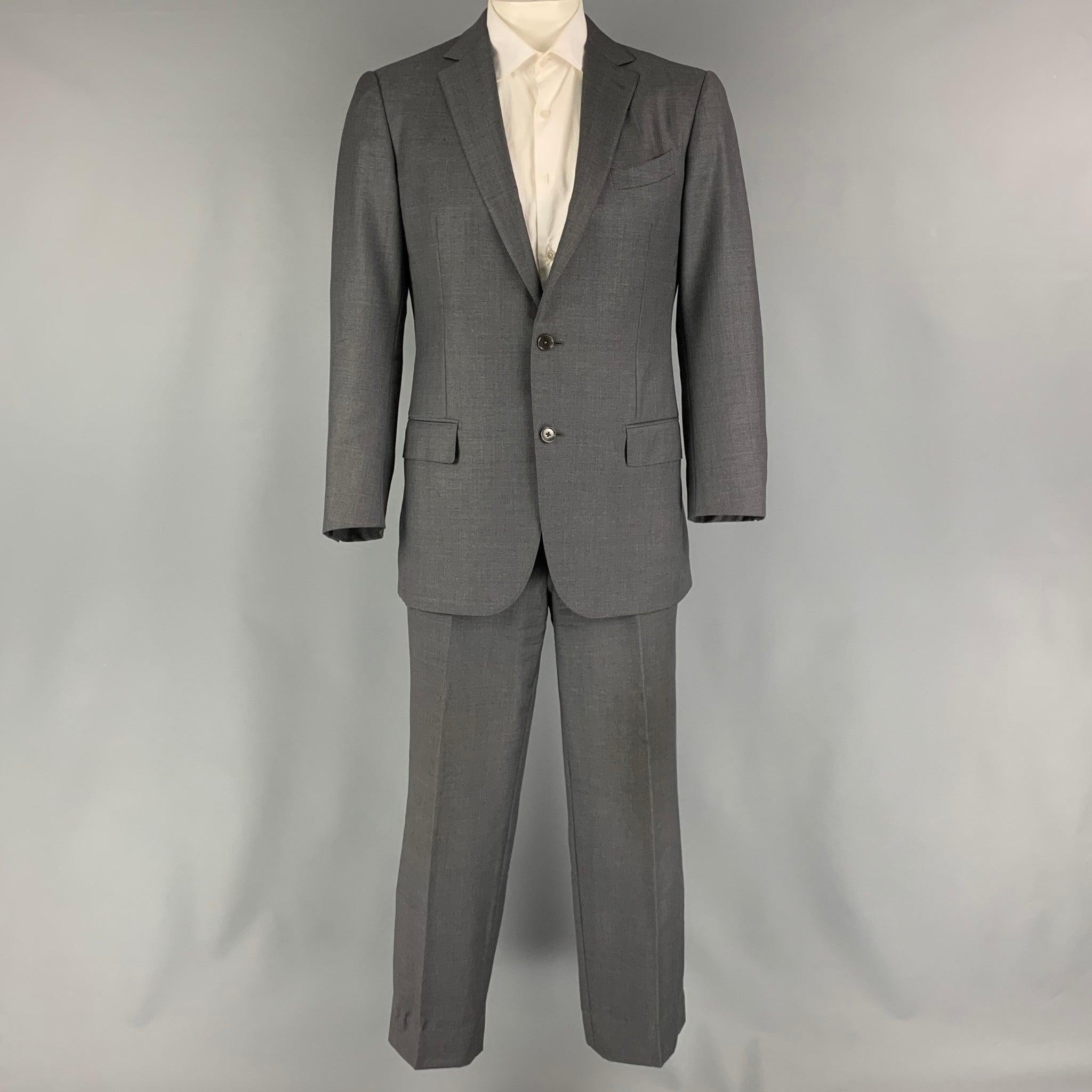ERMENEGILDO ZEGNA suit comes in a grey wool woven material and includes a single breasted, double button sport coat with a notch lapel and matching flat front trousers.Very Good Pre-Owned Condition. 

Marked:   52 R 

Measurements: 
 