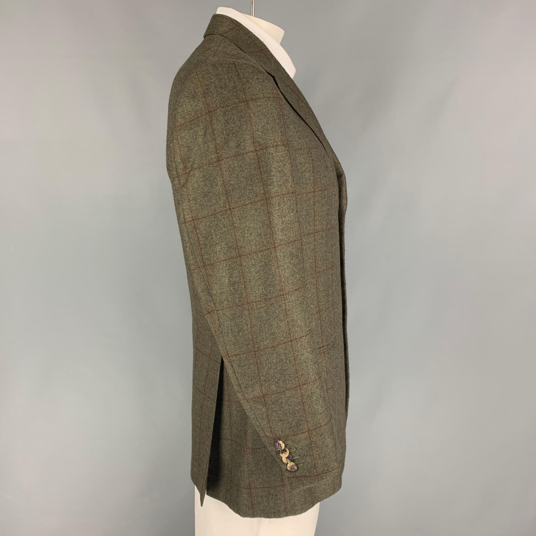 ERMENEGILDO ZEGNA sport coat comes in a olive & brown plaid cashmere with a full liner featuring a notch lapel, flap pockets, double back vent, and a three button closure. 

Very Good Pre-Owned Condition.
Marked: 52

Measurements:

Shoulder: 18