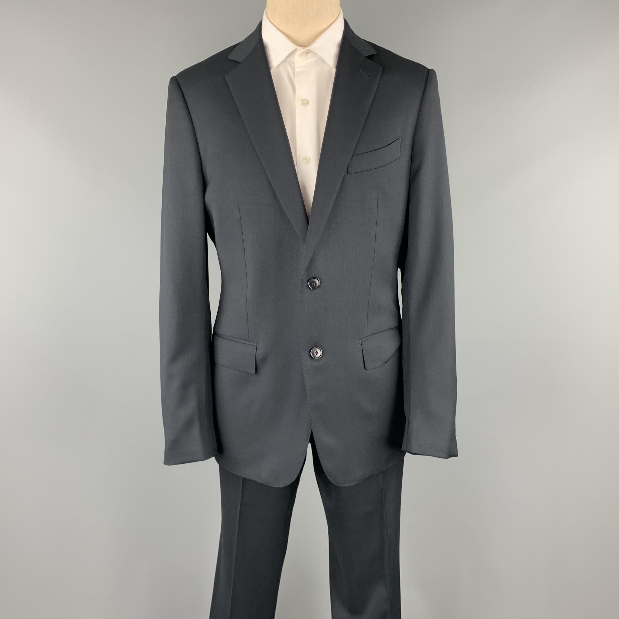 ERMENEGILDO ZEGNA suit comes in a black wool with a full liner and includes a single breasted, two button sport coat with a notch lapel and matching pleated front trousers. 

Excellent Pre-Owned Condition.
Marked: 52 R
Original Retail Price: