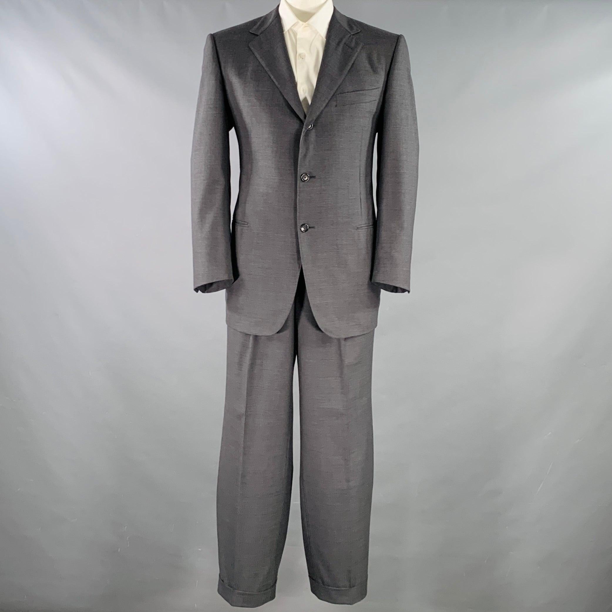 ERMENEGILDO ZEGNA suit
in a charcoal grey wool with full liner and includes a single breasted three button sport coat with a notch lapel and matching pleated trousers.Very Good Pre-Owned Condition. 

Marked:   IT 54 

Measurements: 
 