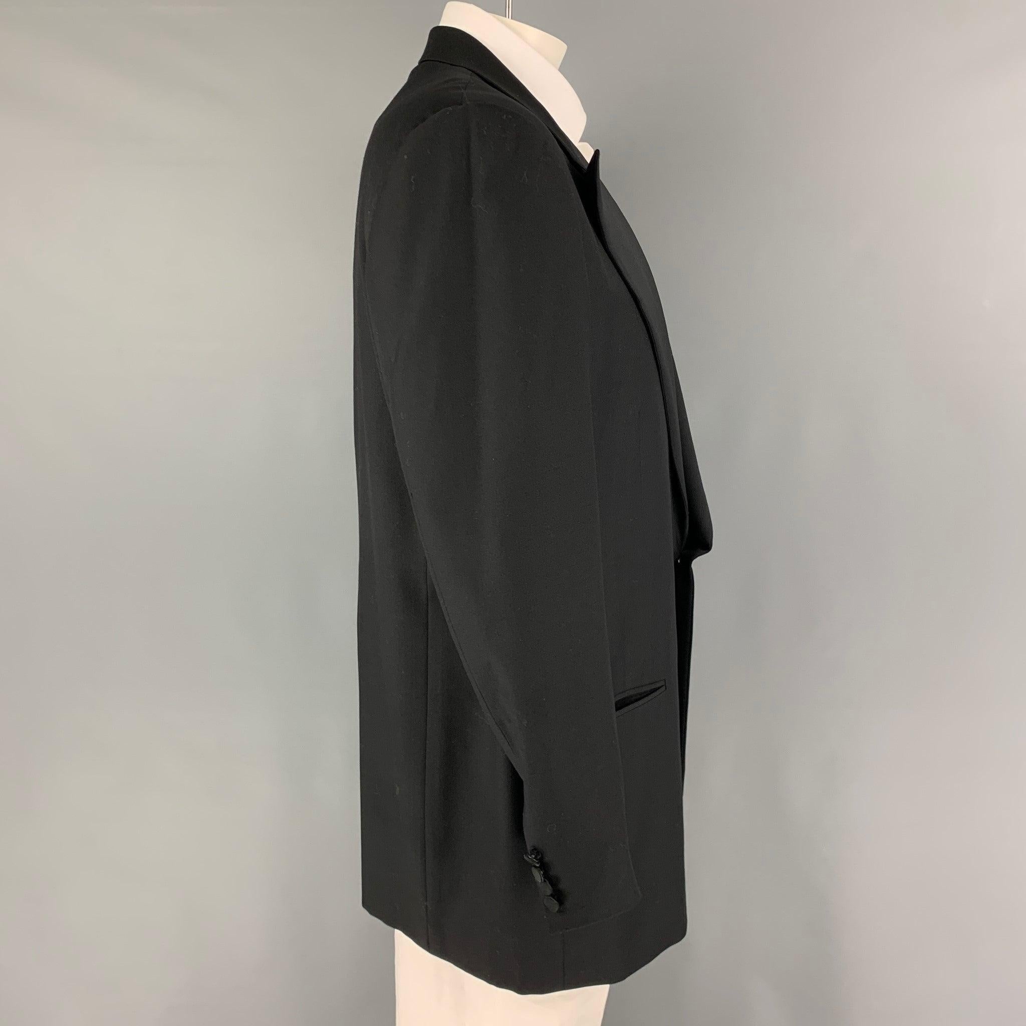 ERMENEGILDO ZEGNA sport coat comes in a black wool with a full liner featuring a peak lapel, slit pockets, and a single button closure.
Excellent
Pre-Owned Condition. 

Marked:   56 

Measurements: 
 
Shoulder: 20 inches Chest: 46 inches Sleeve: